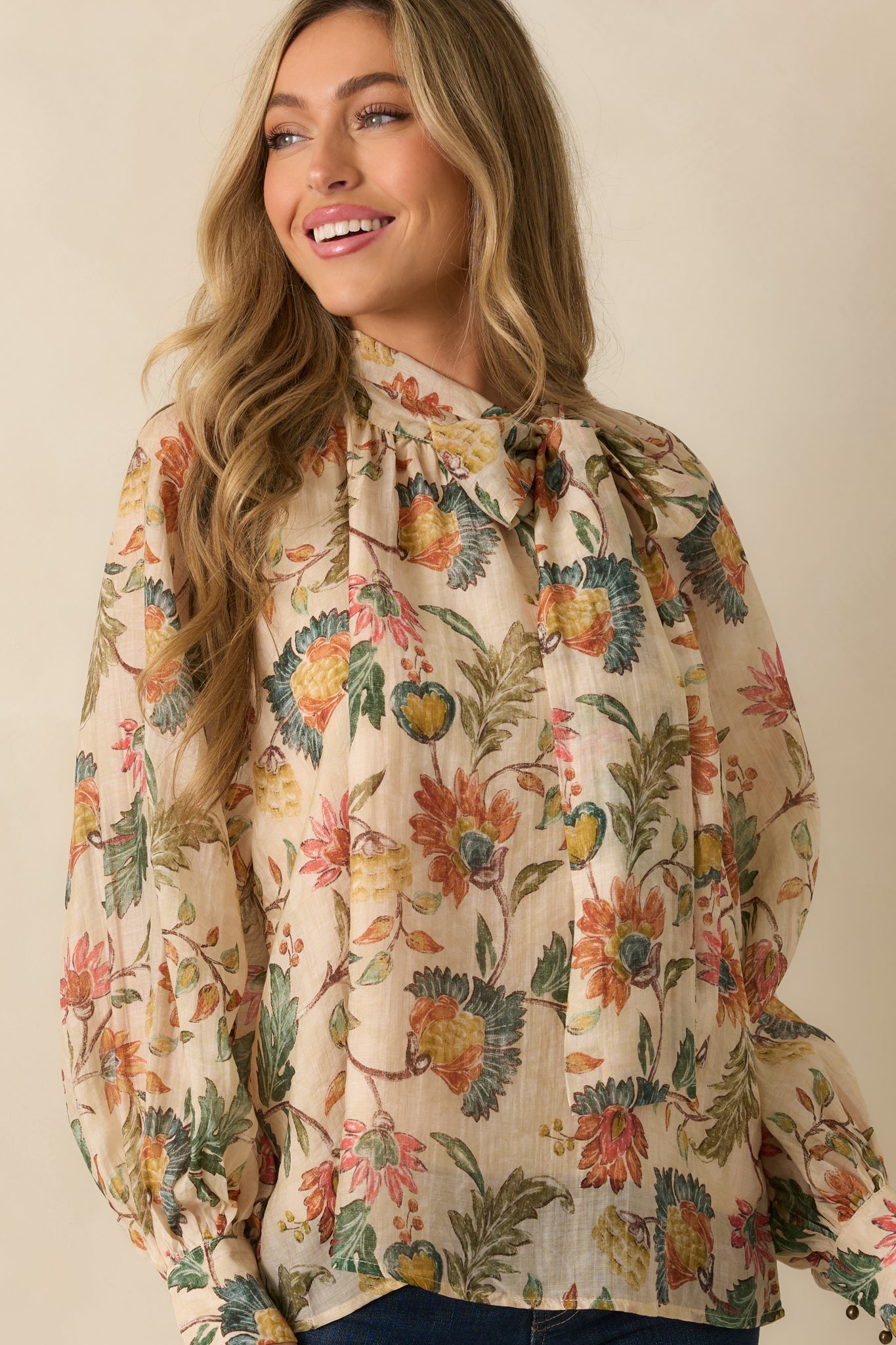 Beige blouse close-up emphasizing the relaxed fit and drape of the fabric.