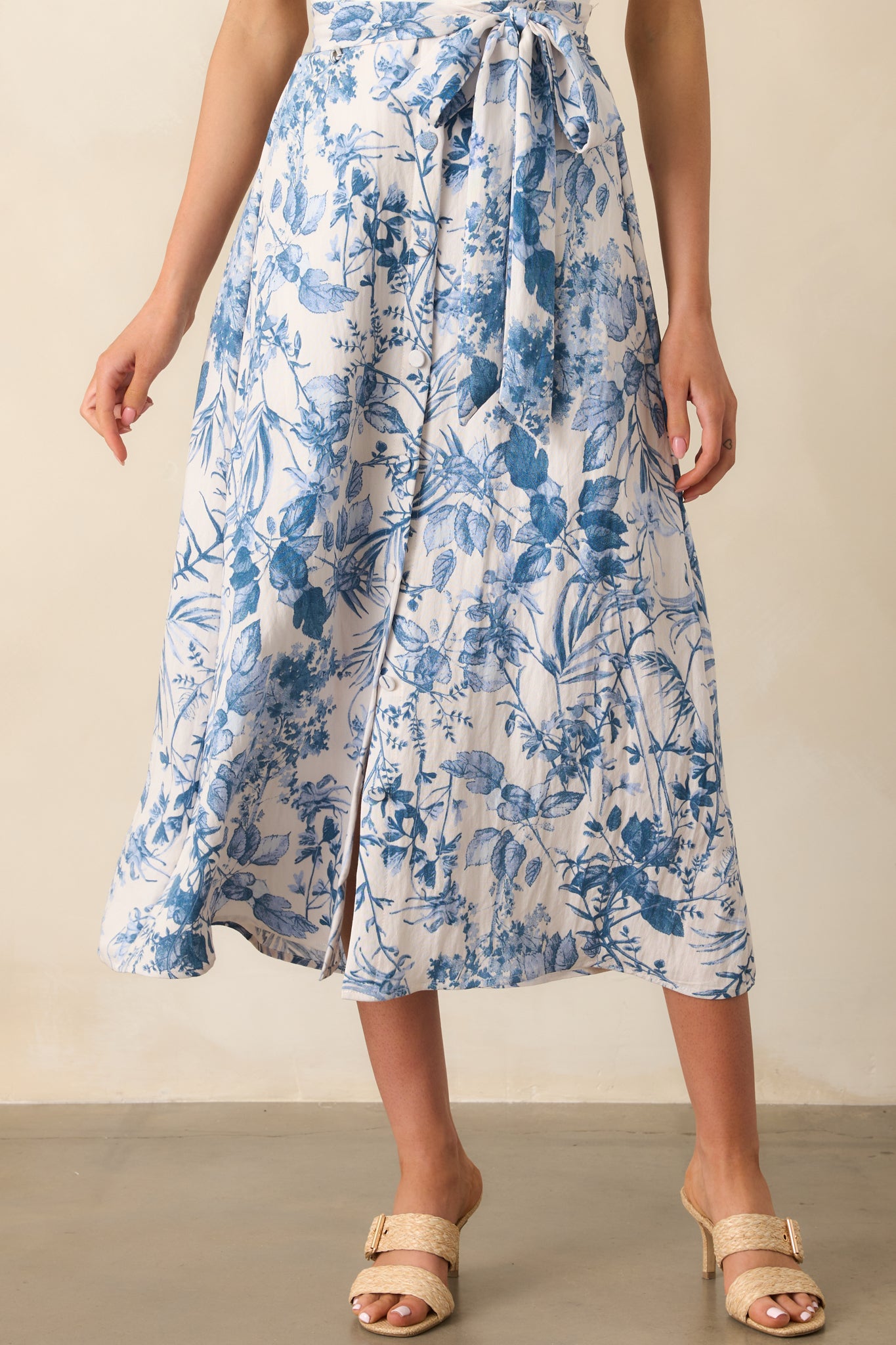 Close-up of the skirt’s fabric and buttons, highlighting the blue floral print and texture of the rayon-linen blend.