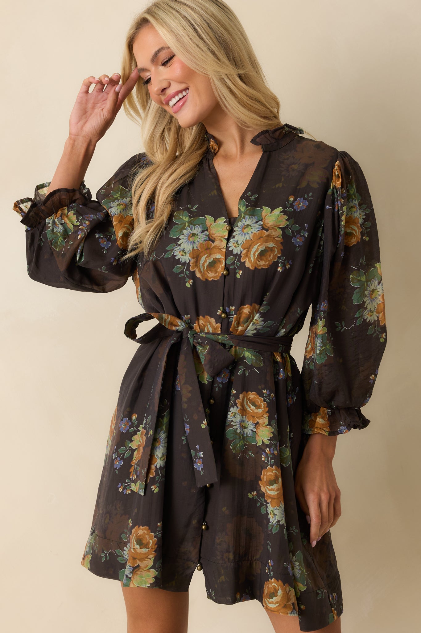 Close-up of the button-down front and collared neckline of the chocolate brown floral mini dress.