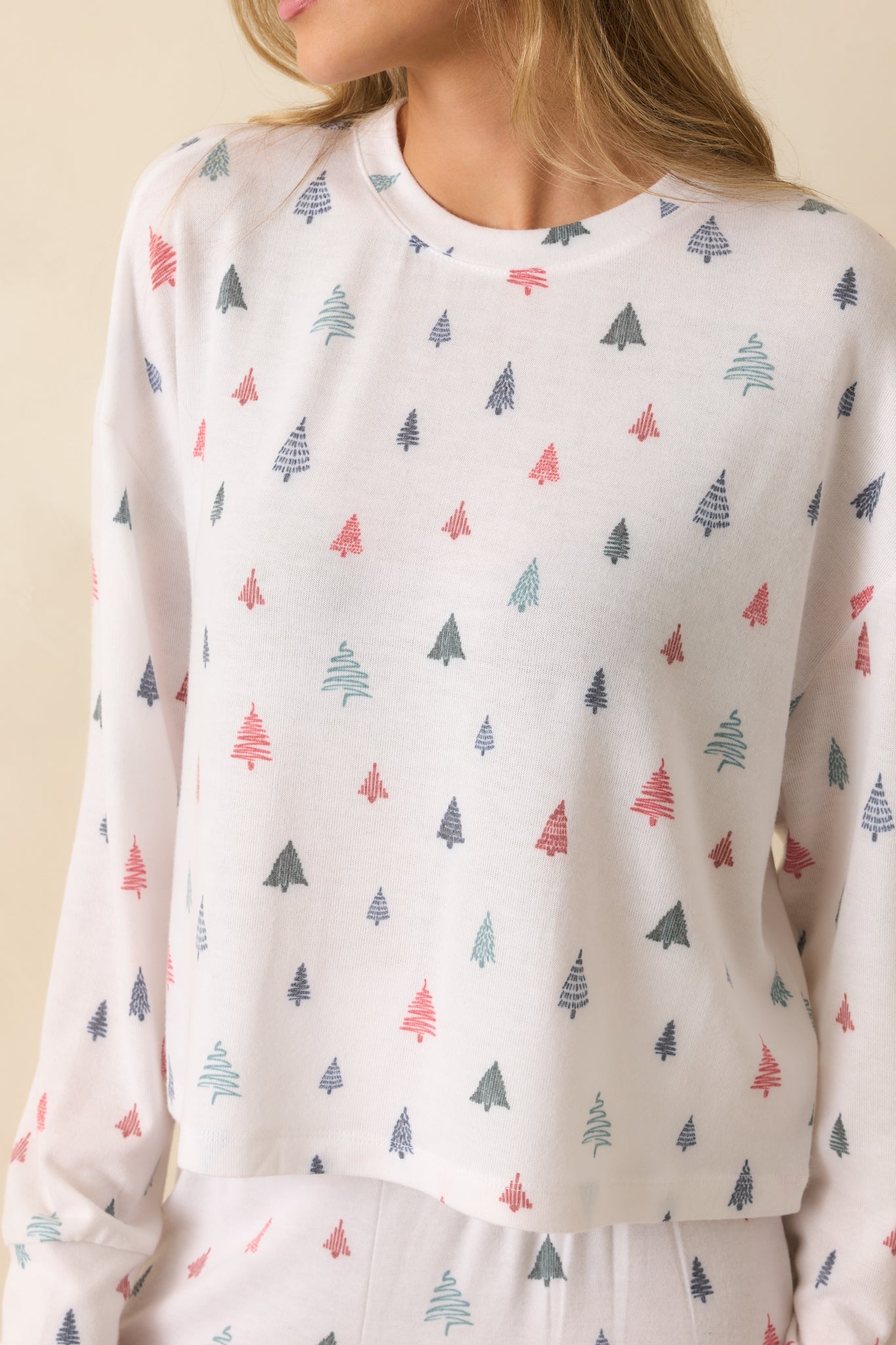 Close-up of brushed sweater knit fabric with alpine tree print, highlighting soft texture and cozy feel.