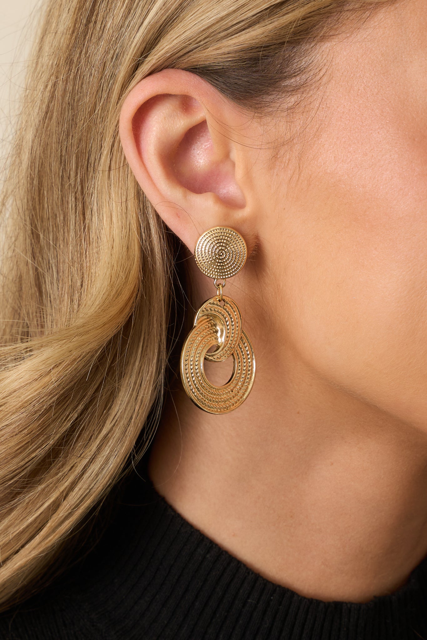 Close-up detail of the earrings, highlighting the thread-like texture and secure post back closure.