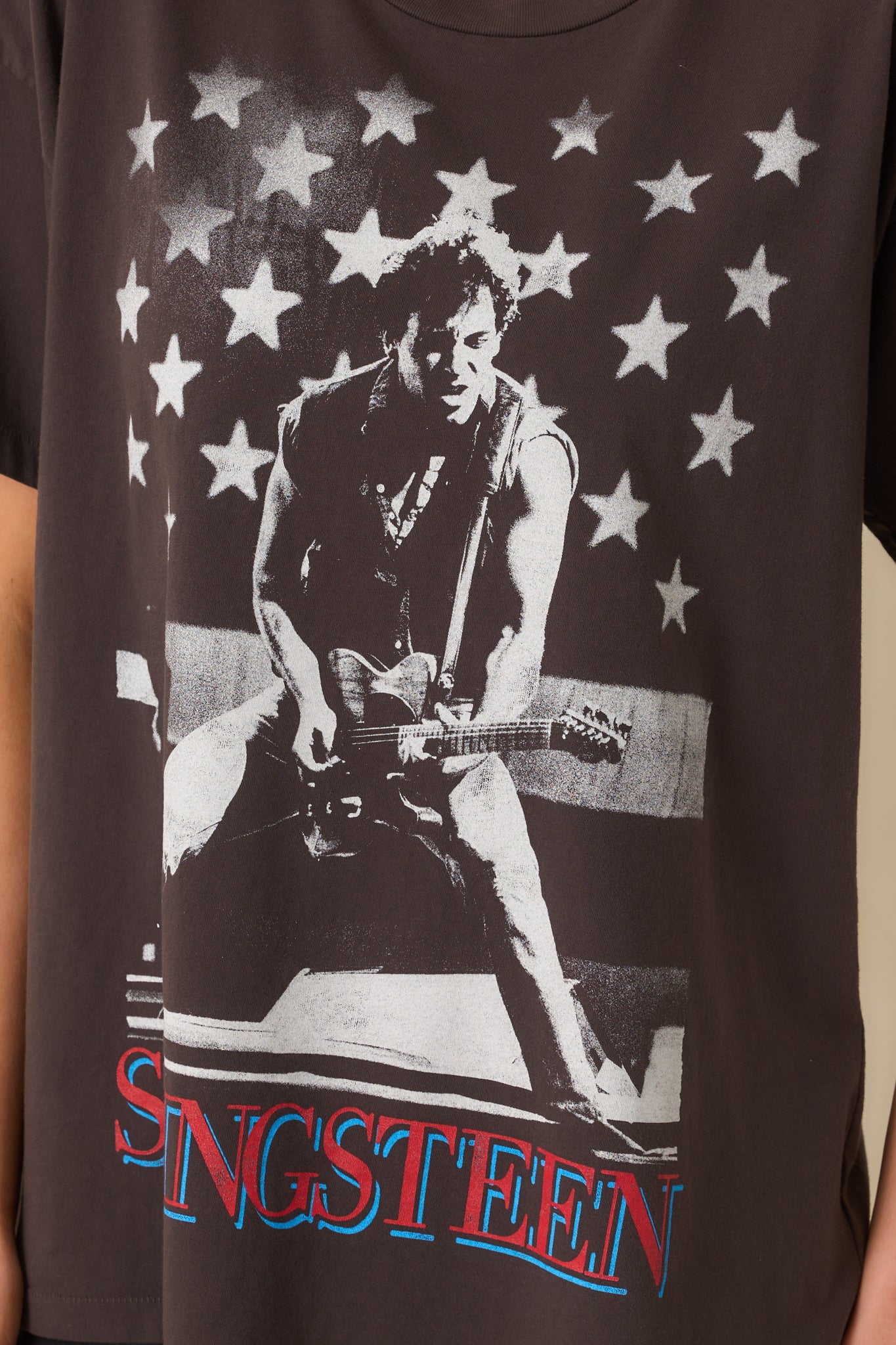 A close-up of the bold front graphic featuring star accents and large Bruce Springsteen lettering.