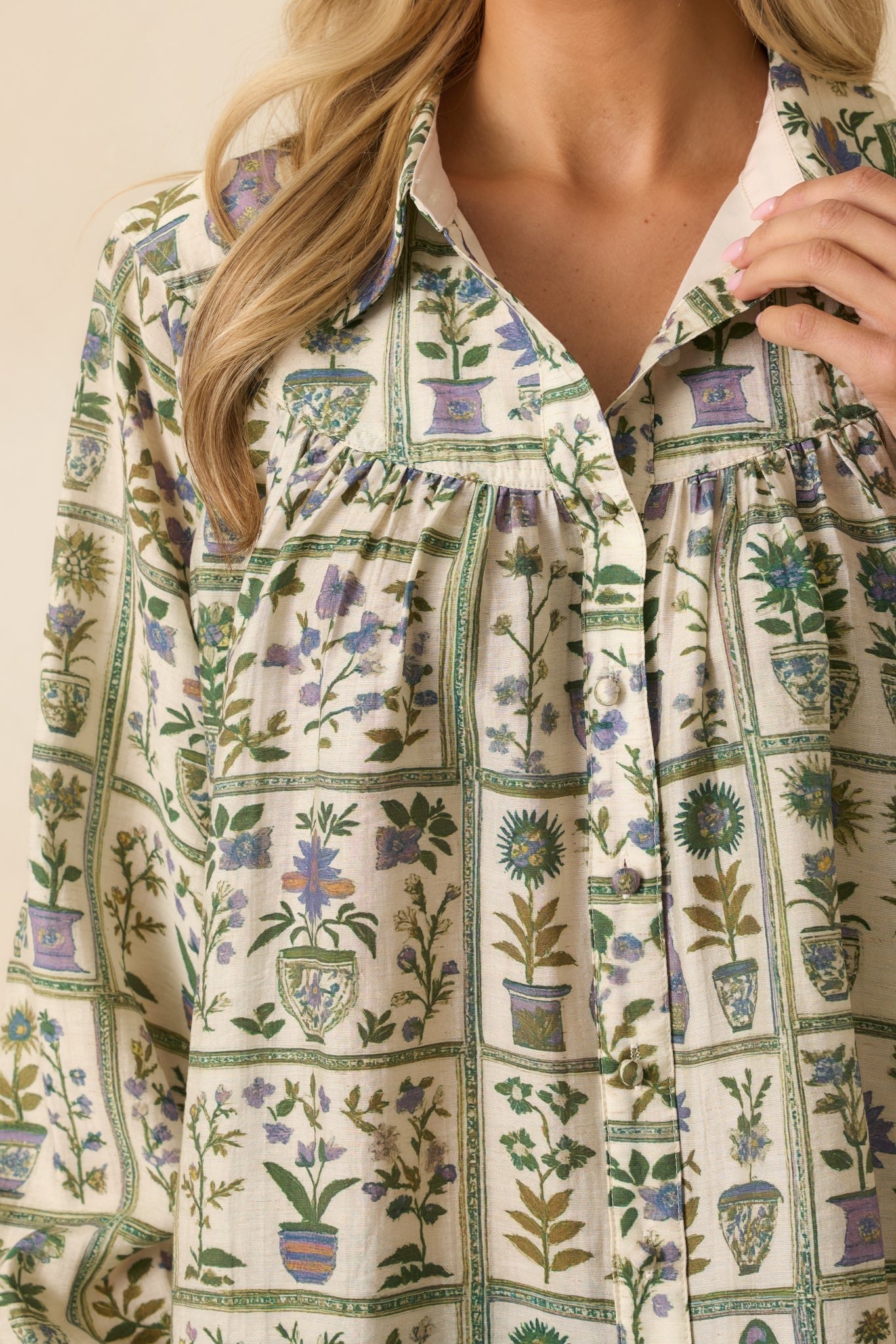 Zoomed-in view of the green floral fabric, showing intricate multicolor flowers and stitching on the yoke.