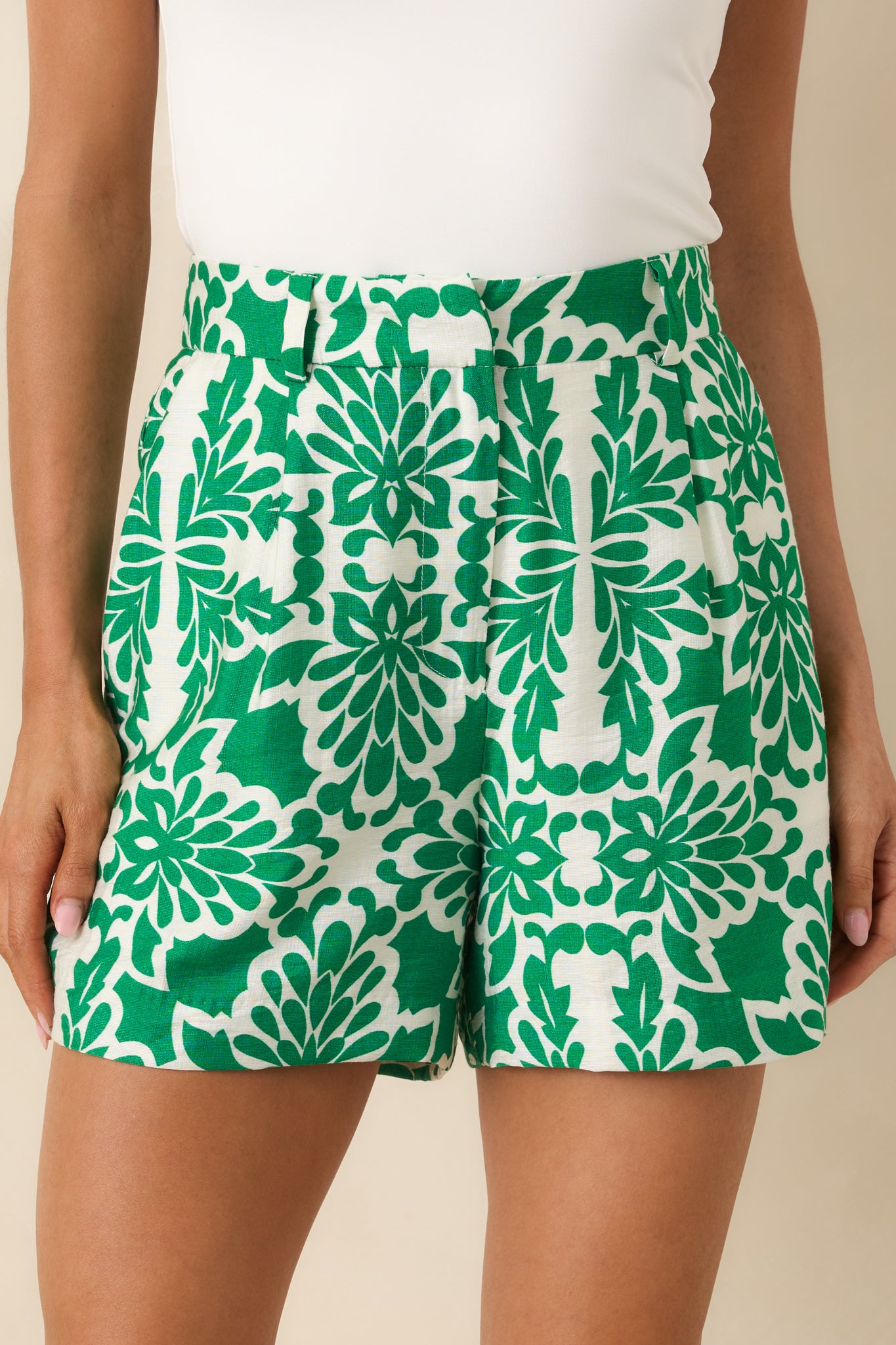 Closer look at the green and ivory print across the tailored shorts.
