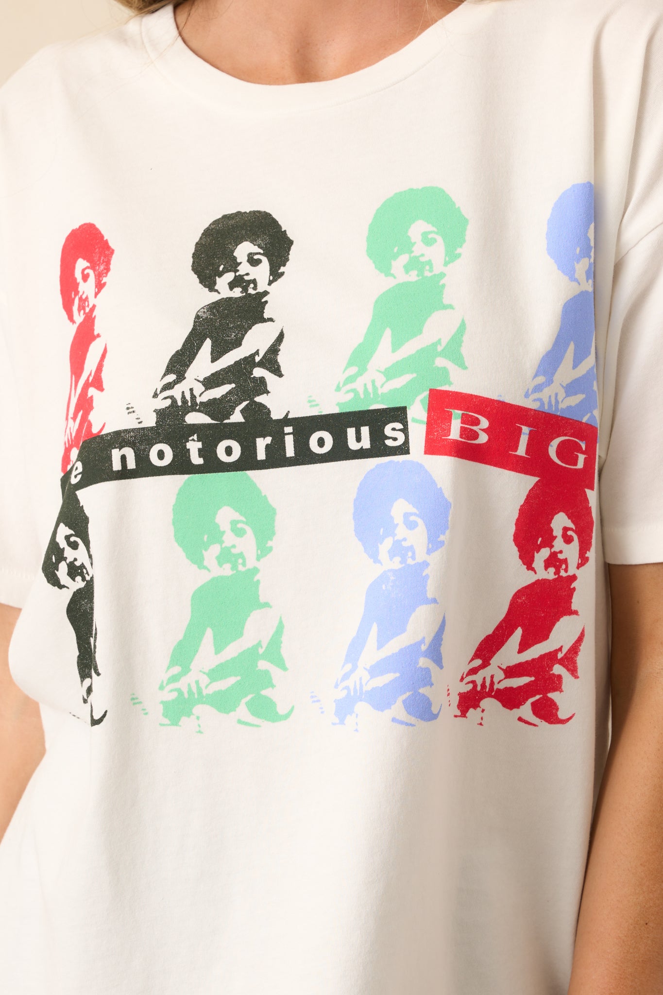 Close-up of the multicolor graphic on the vintage white tee, showing intricate details of the design inspired by The Notorious B.I.G. album covers.