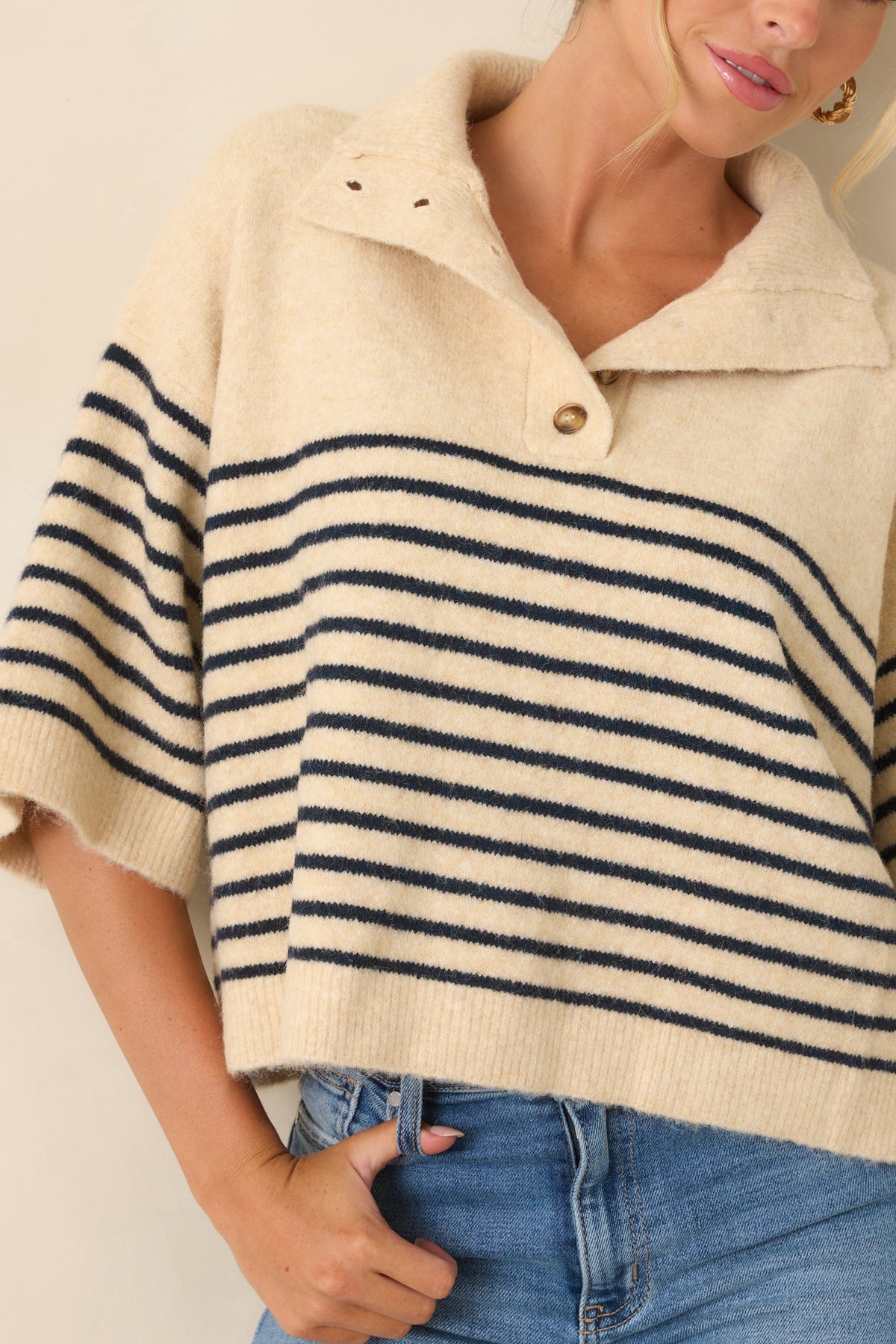 Close-up view of the brushed knit texture, wide collar, and partial button placket.