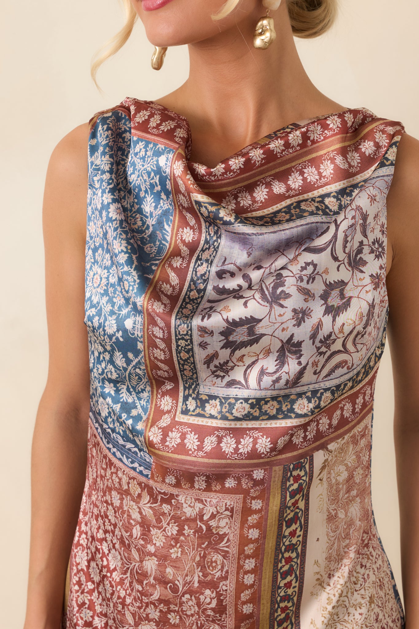 Close-up view of the cowl neckline, smooth fabric, and softly gathered draping on the bodice.