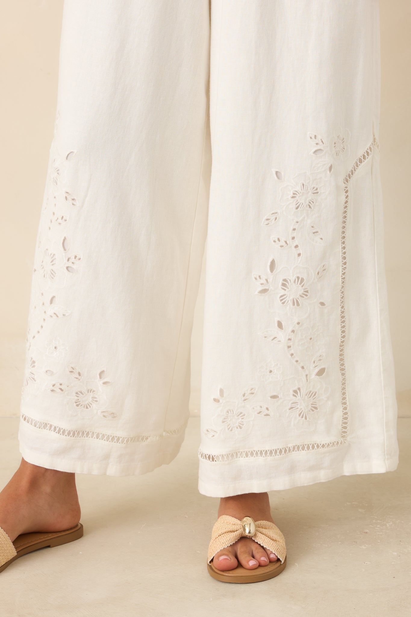 Close-up view of the floral embroidery, openwork trim, and intricate lower leg detailing.