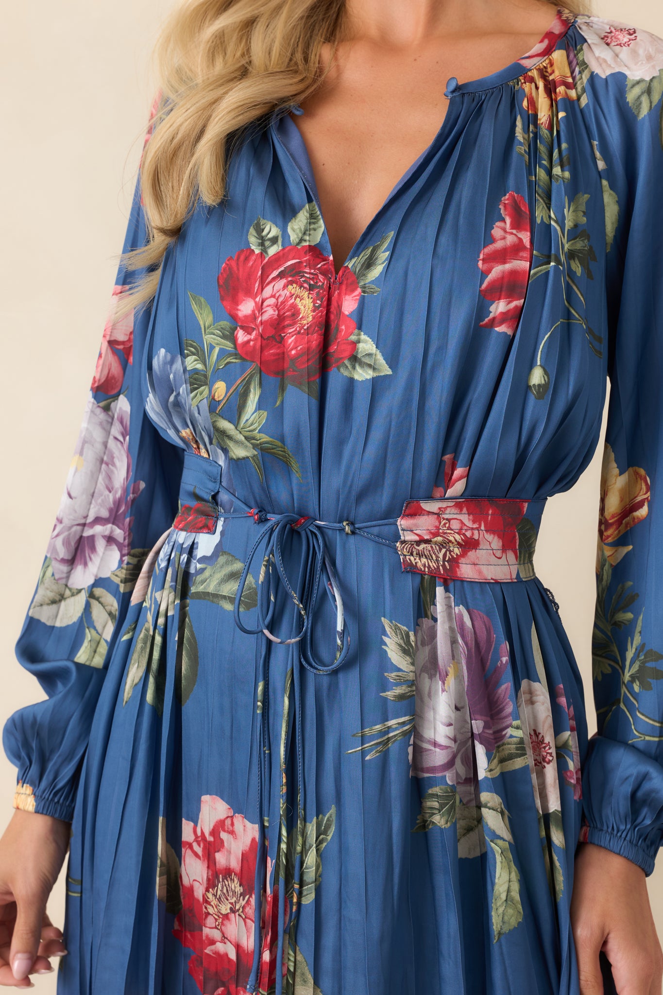 Close-up view of the oversized floral print, delicate pleating, gathered neckline, and textured fabric details.