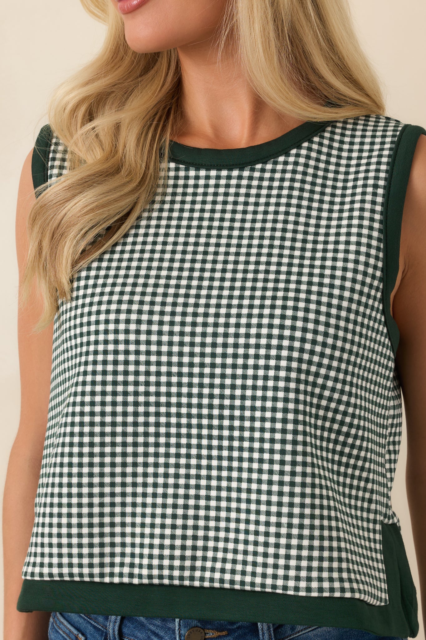 Close-up view of the gingham pattern, contrast trim, and fabric-covered button details.
