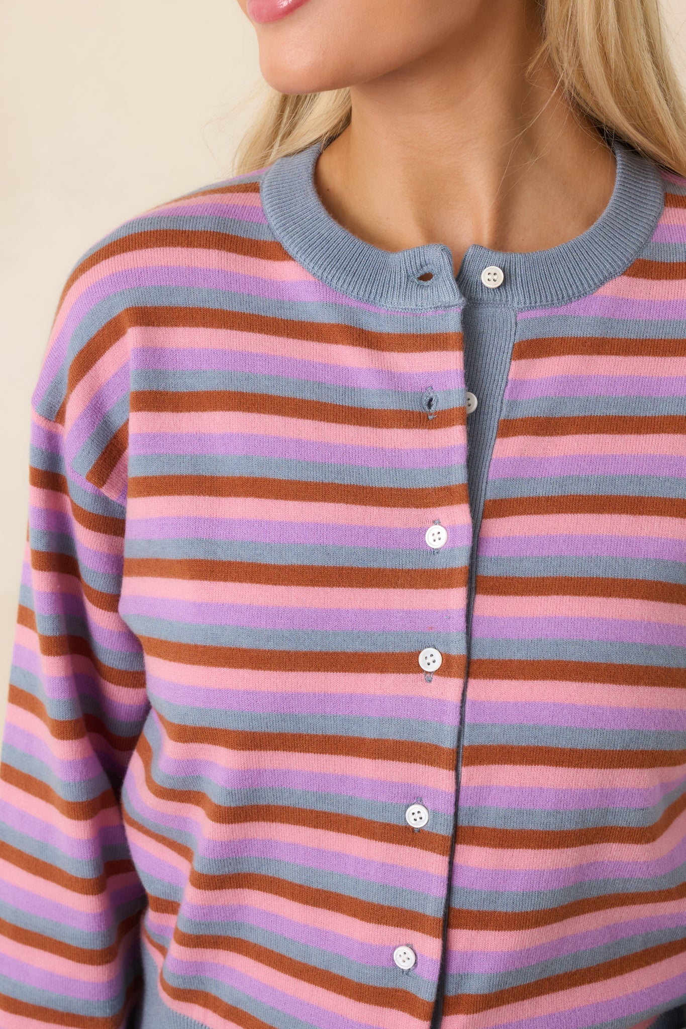 Close-up of ribbed trim and multicolor stripe pattern on knit cardigan.