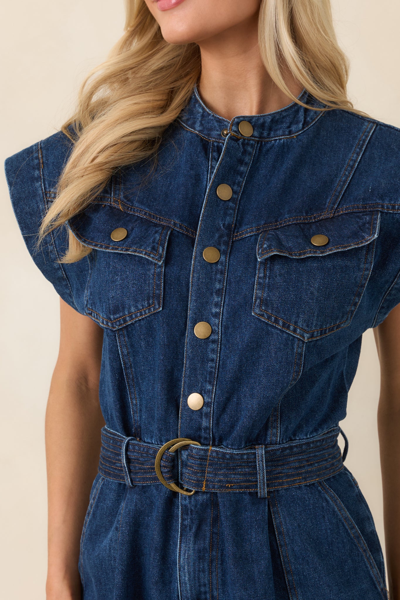 Close-up of snap-button front, chest flap pocket, and self-tie belt with metal buckle.