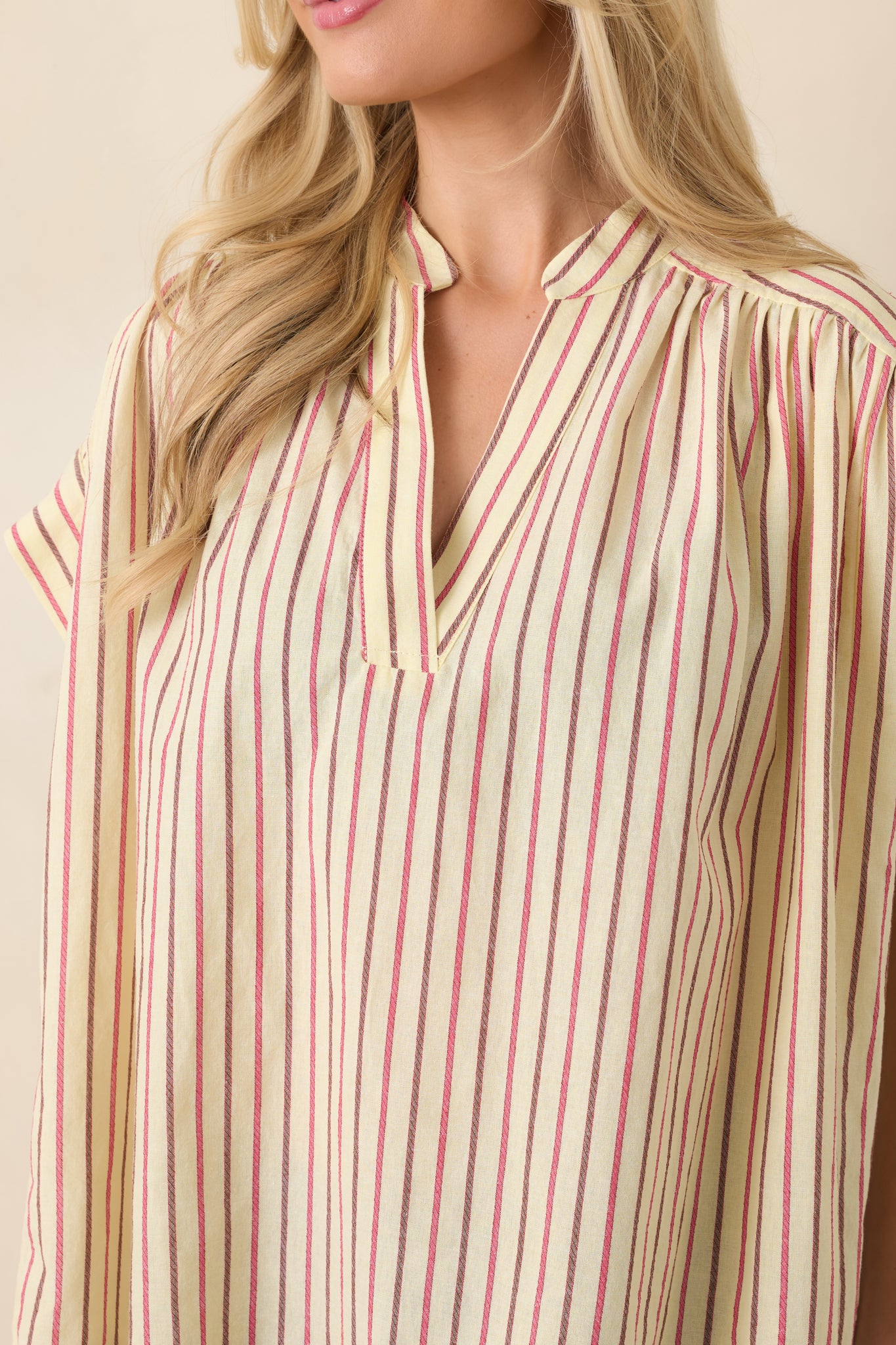 Close-up of split V-neckline and subtle stand collar design.