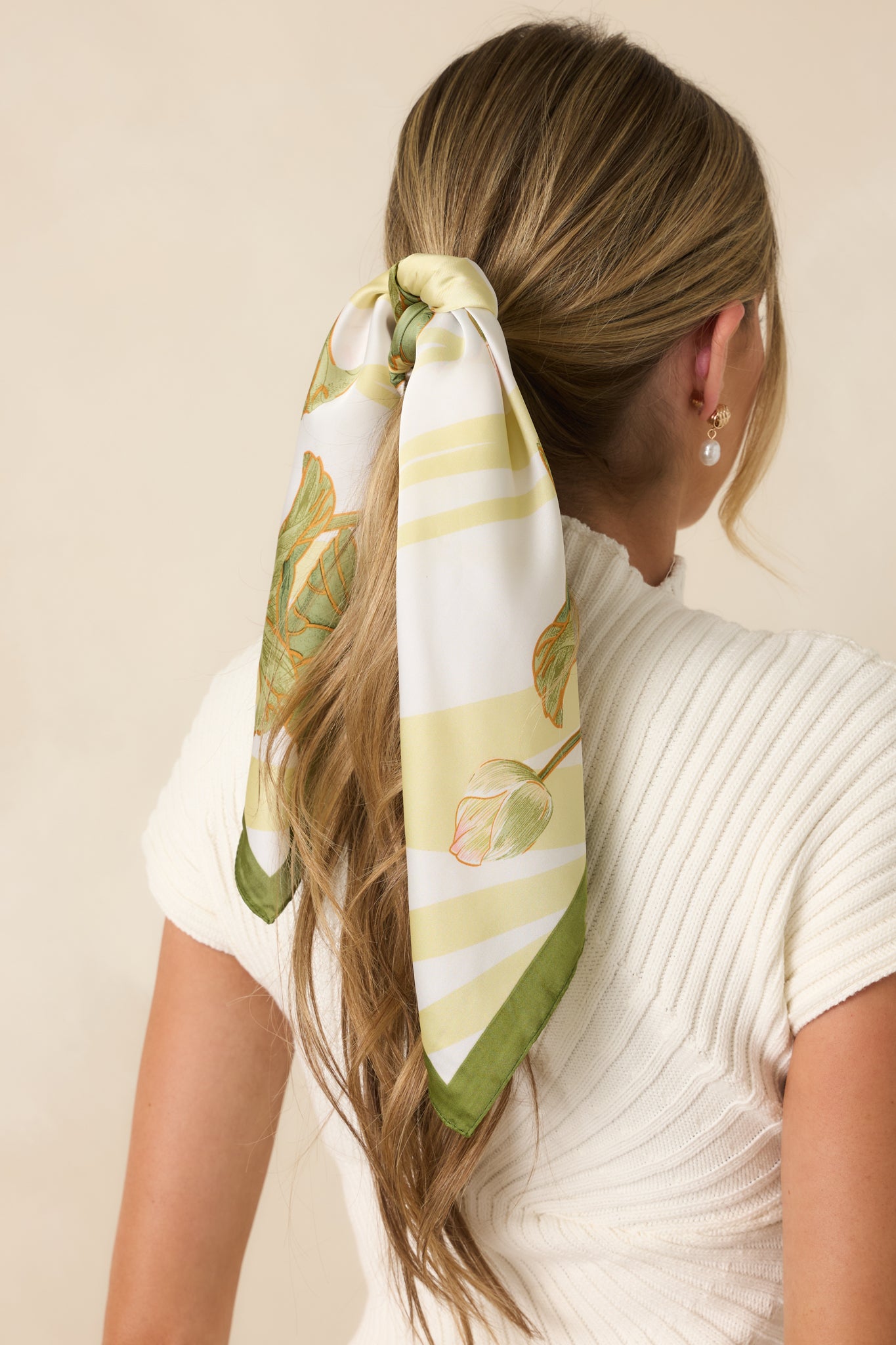 Close-up of the hair scarf featuring the smooth silky texture, waterlily artwork, and colorful watercolor-inspired detailing.