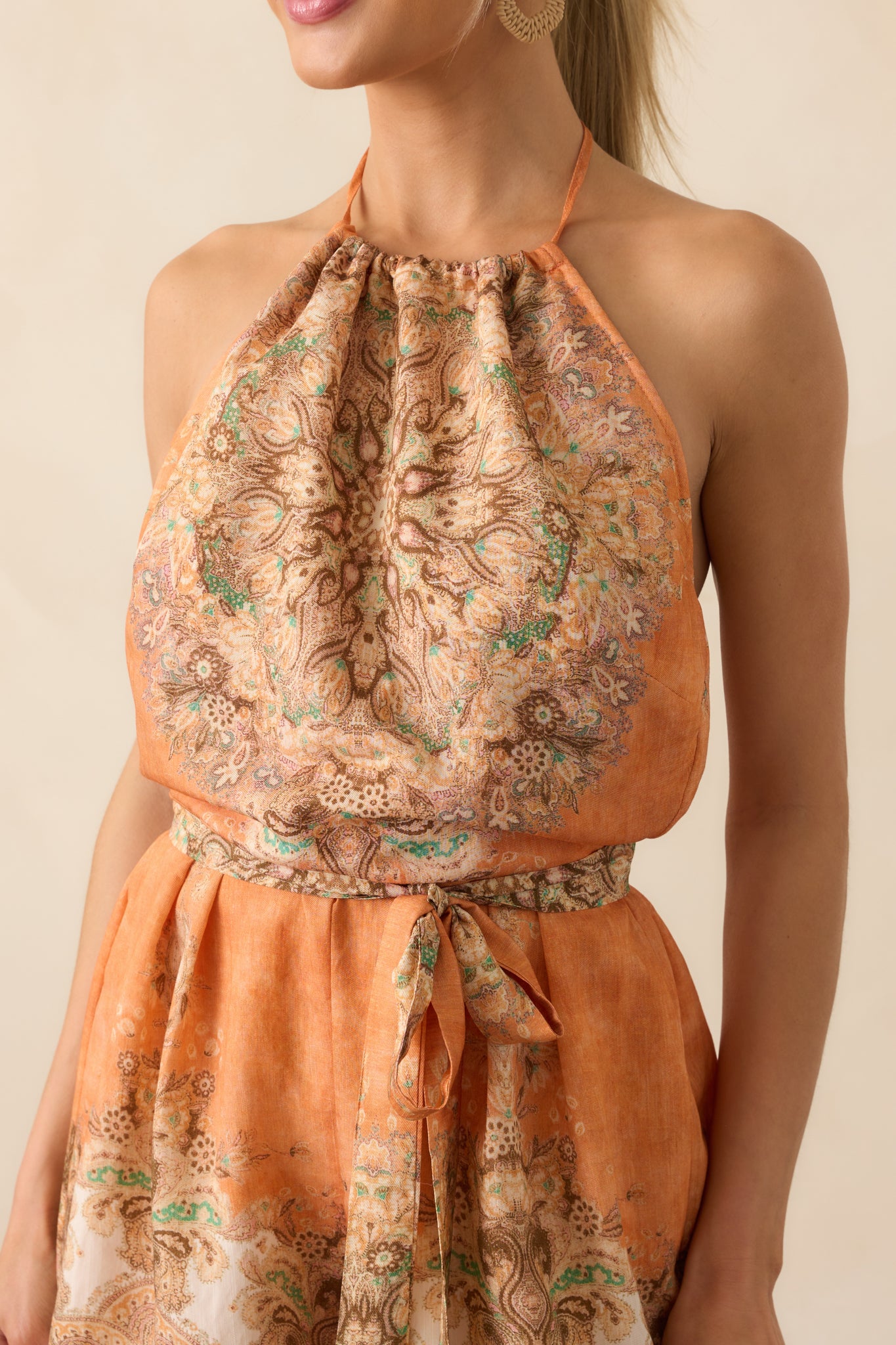 Close-up of the neckline and chest area showing the fine multicolor print, drawstring ends, and texture of the lightweight fabric.