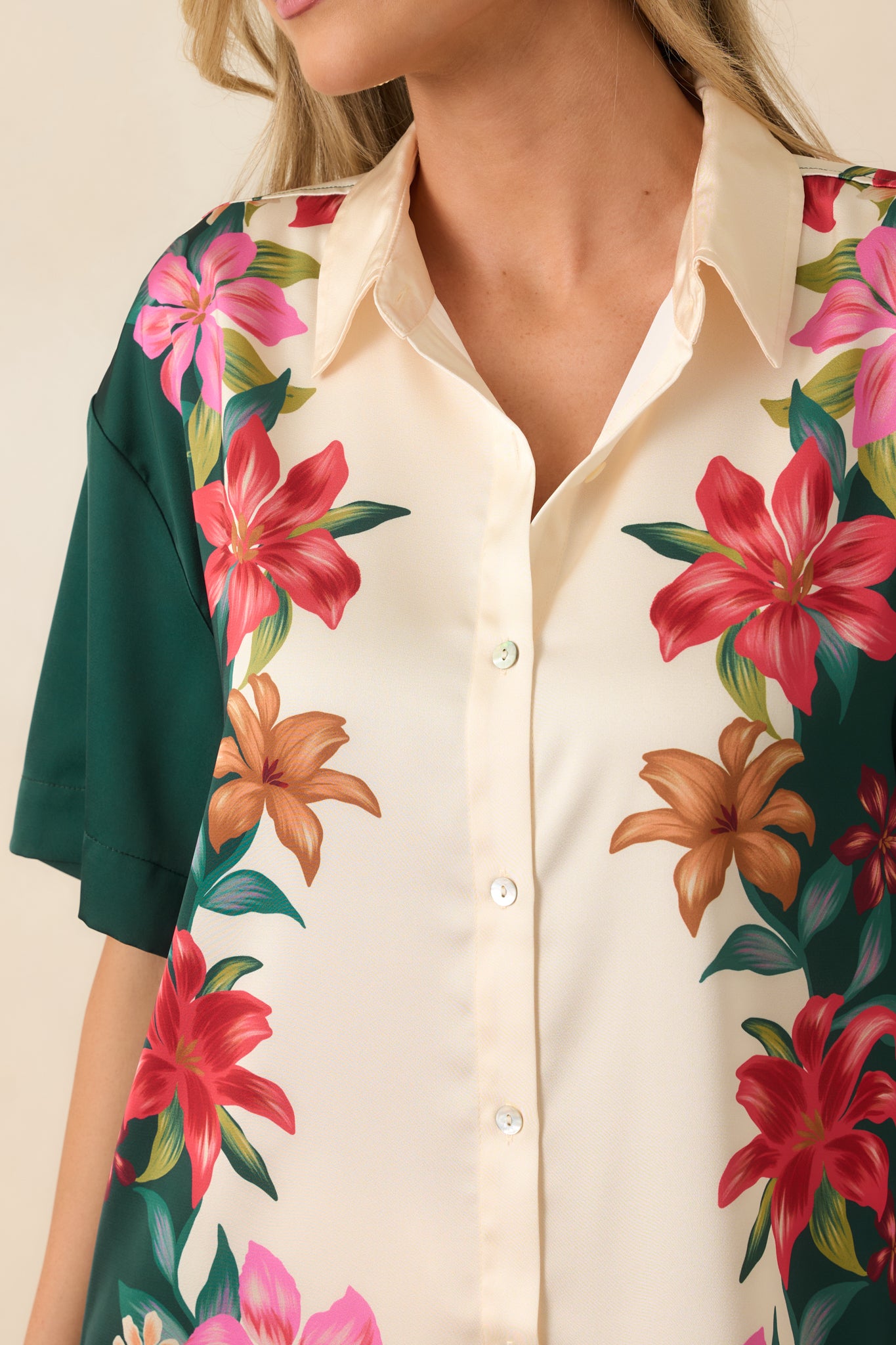 Close-up of the teal multi floral satin top featuring the silky fabric texture, floral border print, buttons, and collar details.