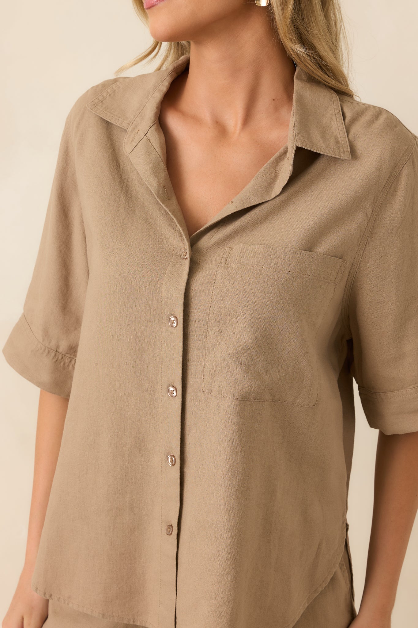 Close-up of the washed linen blend fabric, button-front detailing, and chest pocket on the taro brown top.