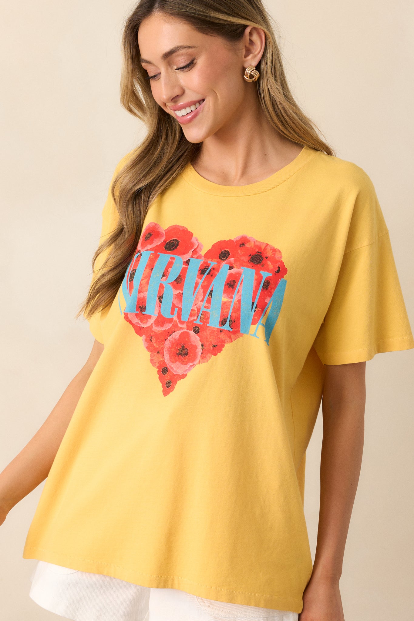 A detailed view of the vibrant heart graphic and the 'Nirvana' stamp, making this tee a fun, eye-catching piece.