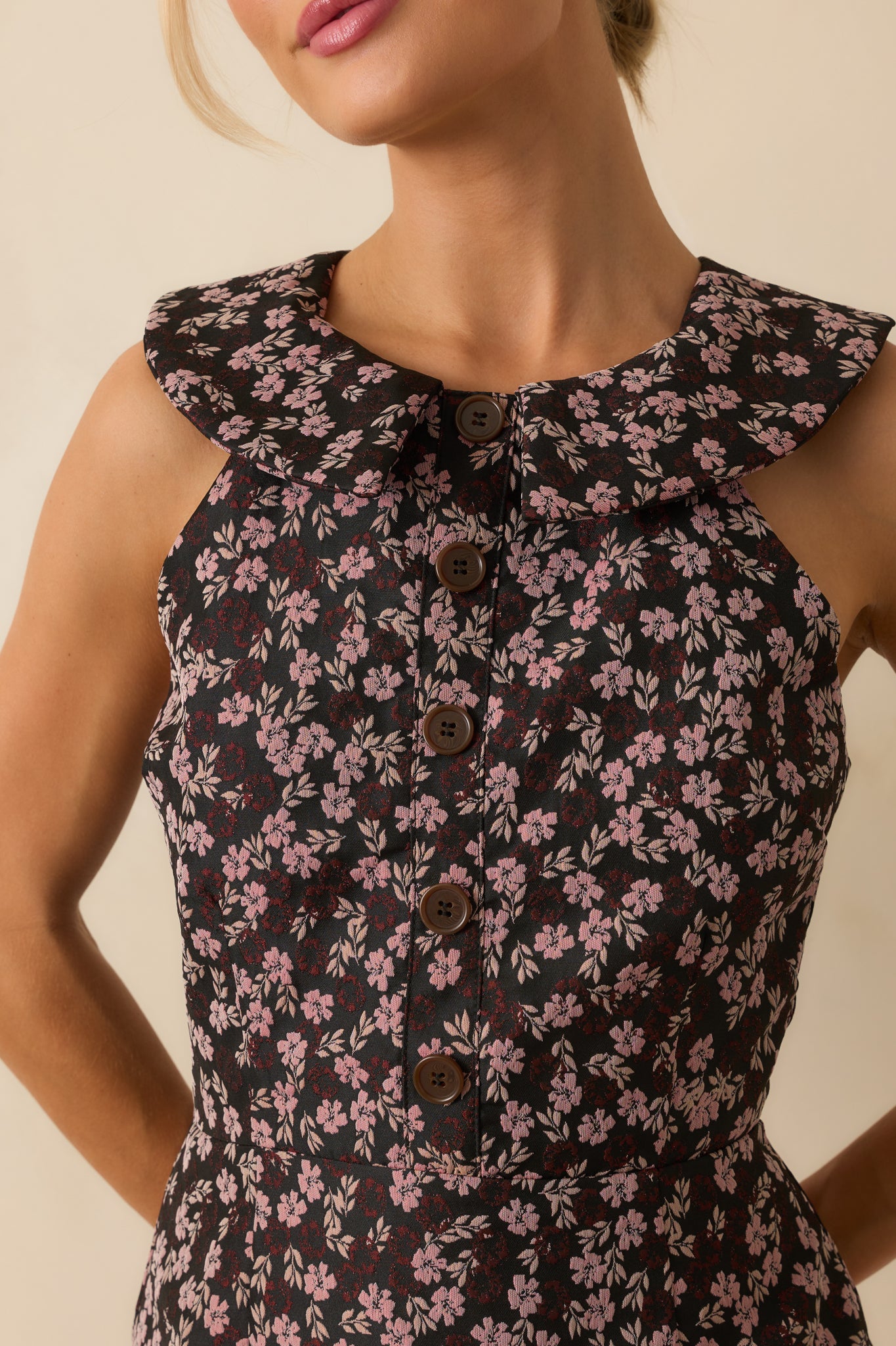 Close-up of the pink floral jacquard fabric and faux button front on the midi dress.