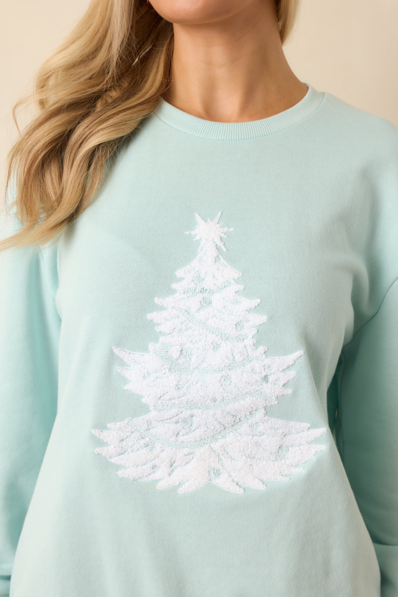Close-up showing the raised white Christmas tree texture and soft knit fabric surface.