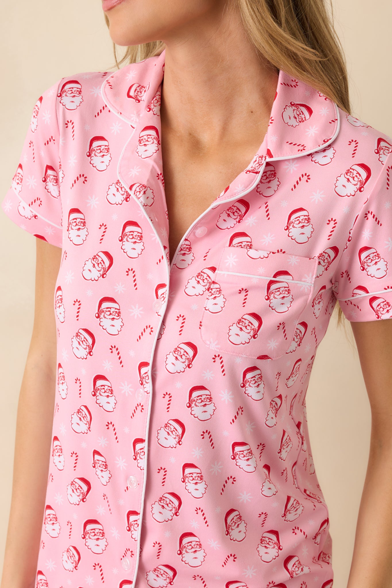 Close-up showing the Santa and candy cane print, stitched collar, and front buttons.