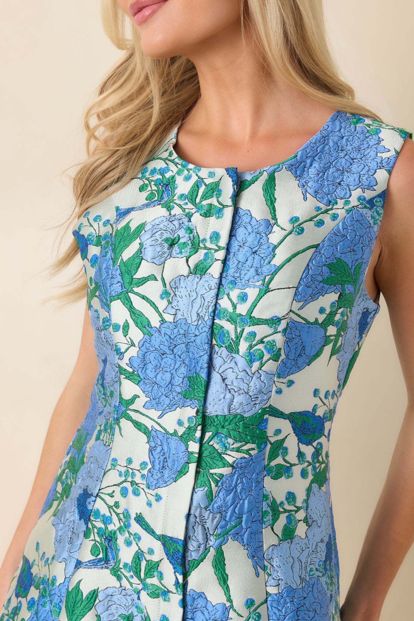 Close-up of the textured floral jacquard fabric showcasing the intricate blue and green botanical pattern.