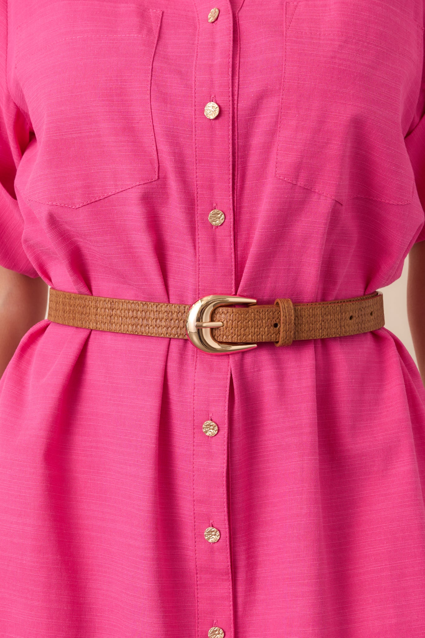 Close-up of the belt’s woven-texture faux leather and gold-tone buckle.