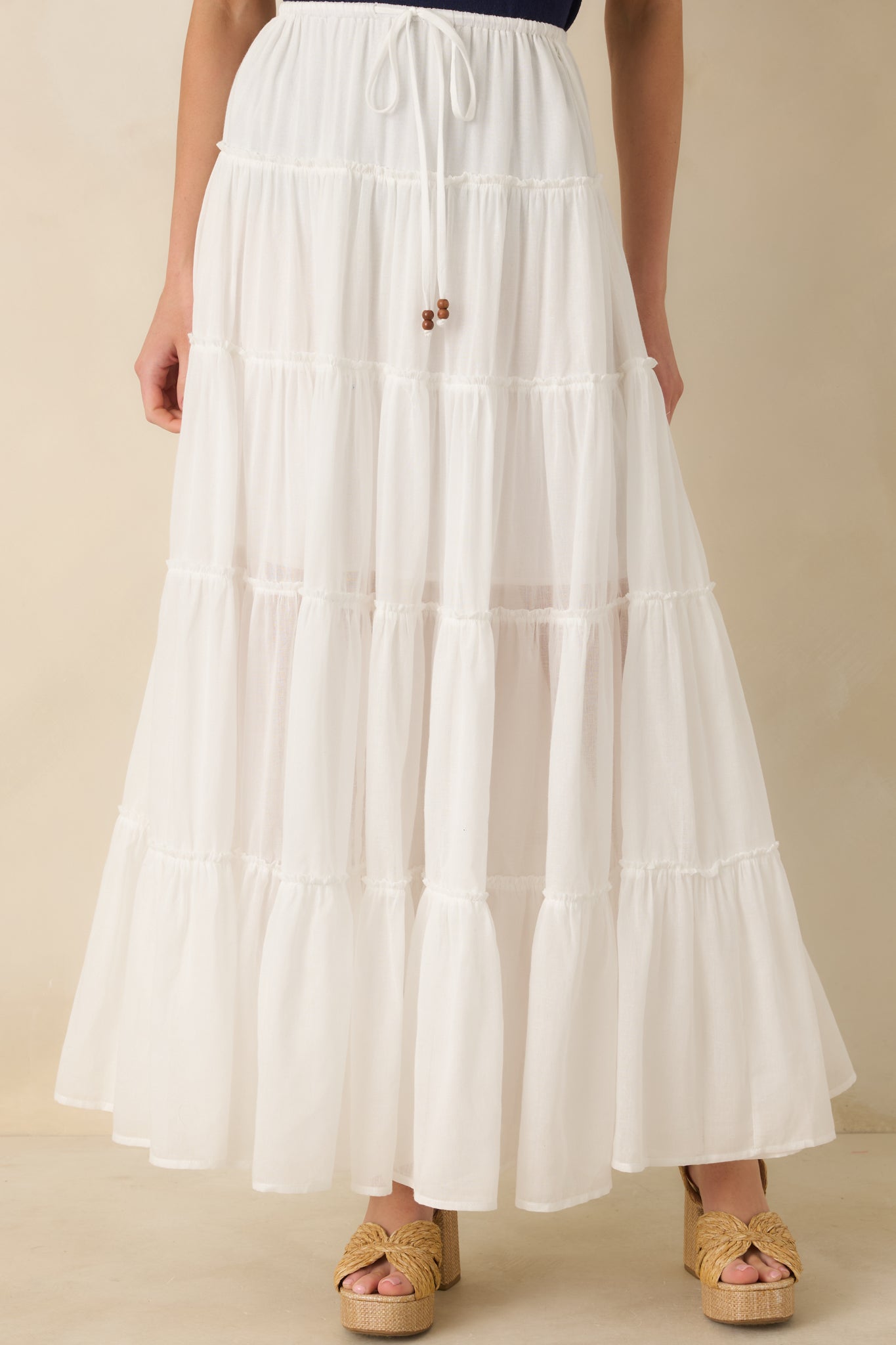 Close view of elastic waistband with adjustable drawstring tie and subtle bead detailing.