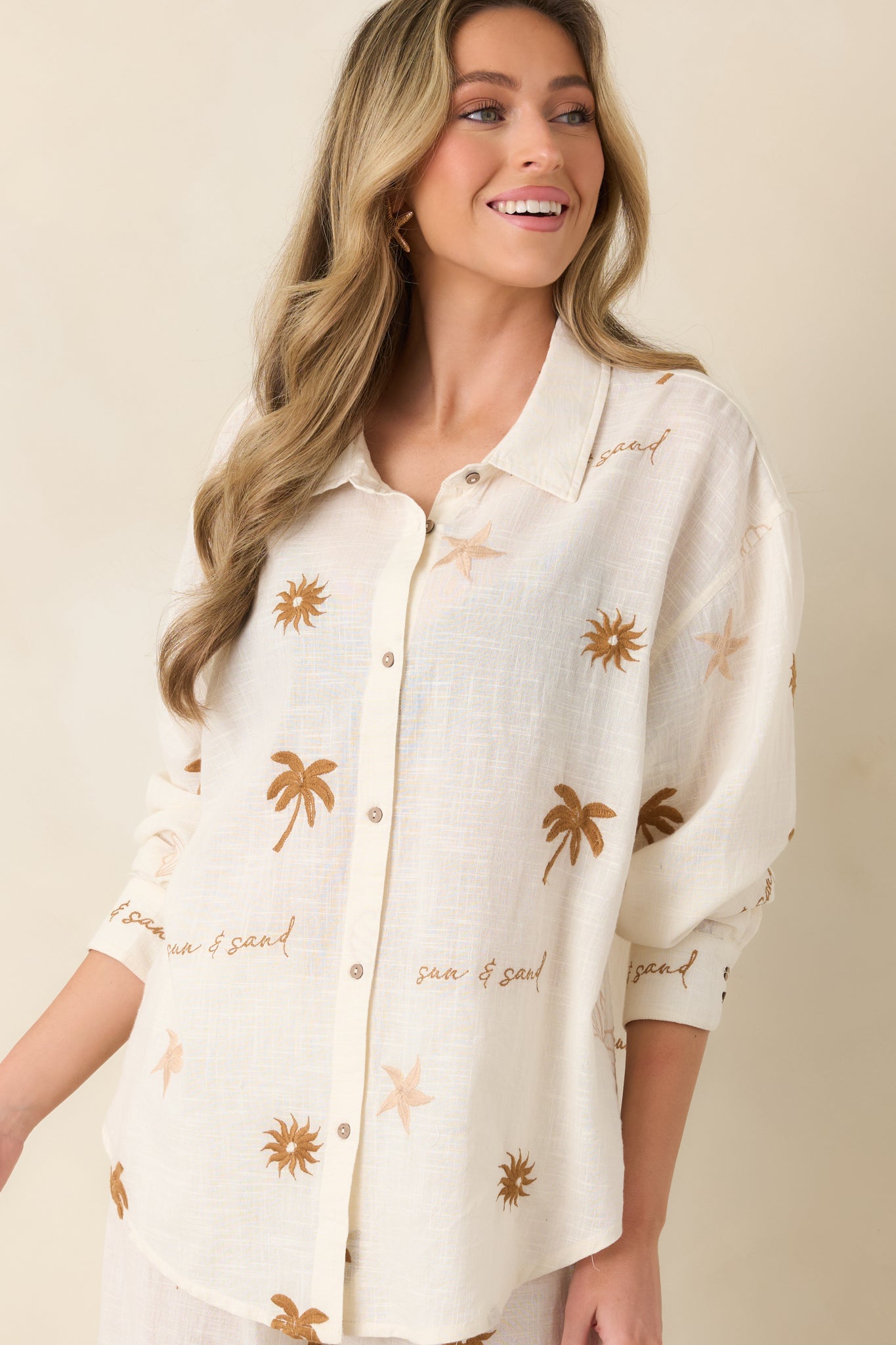 Close view of full button front and breathable cotton fabric in light beige.