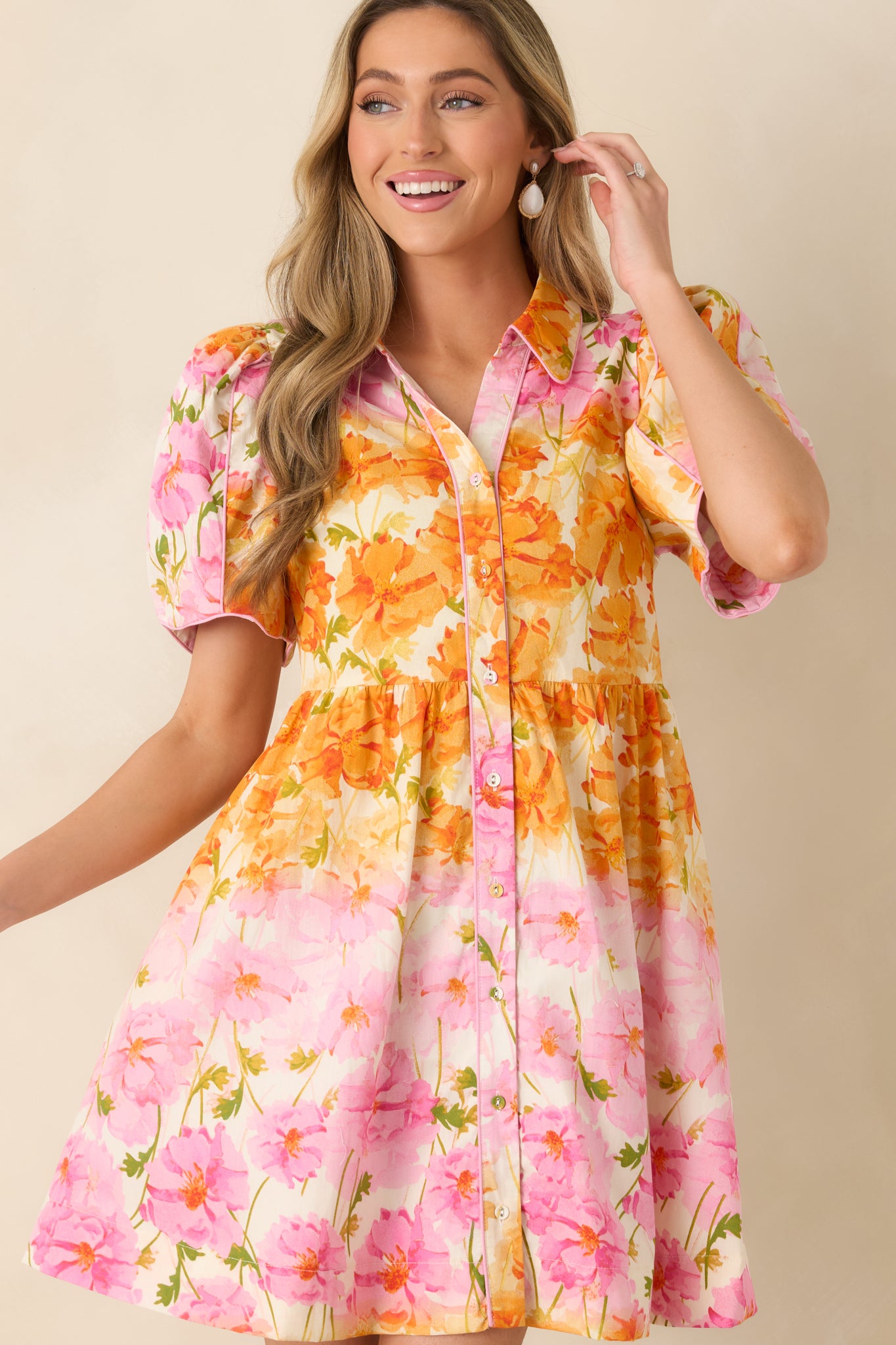 Close view of the collared neckline with pink piping and a clean button-front detail.