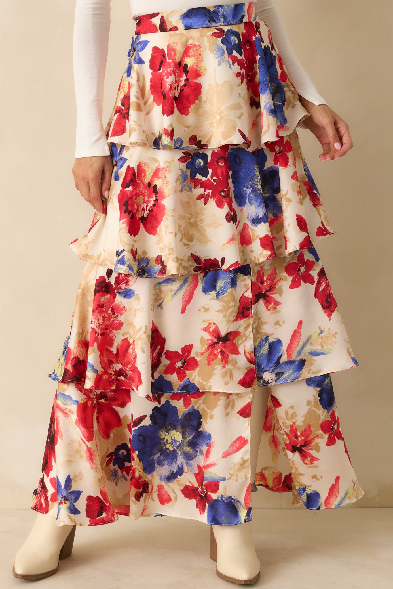 Close view of the elastic back waistband and upper tier of the floral maxi skirt.