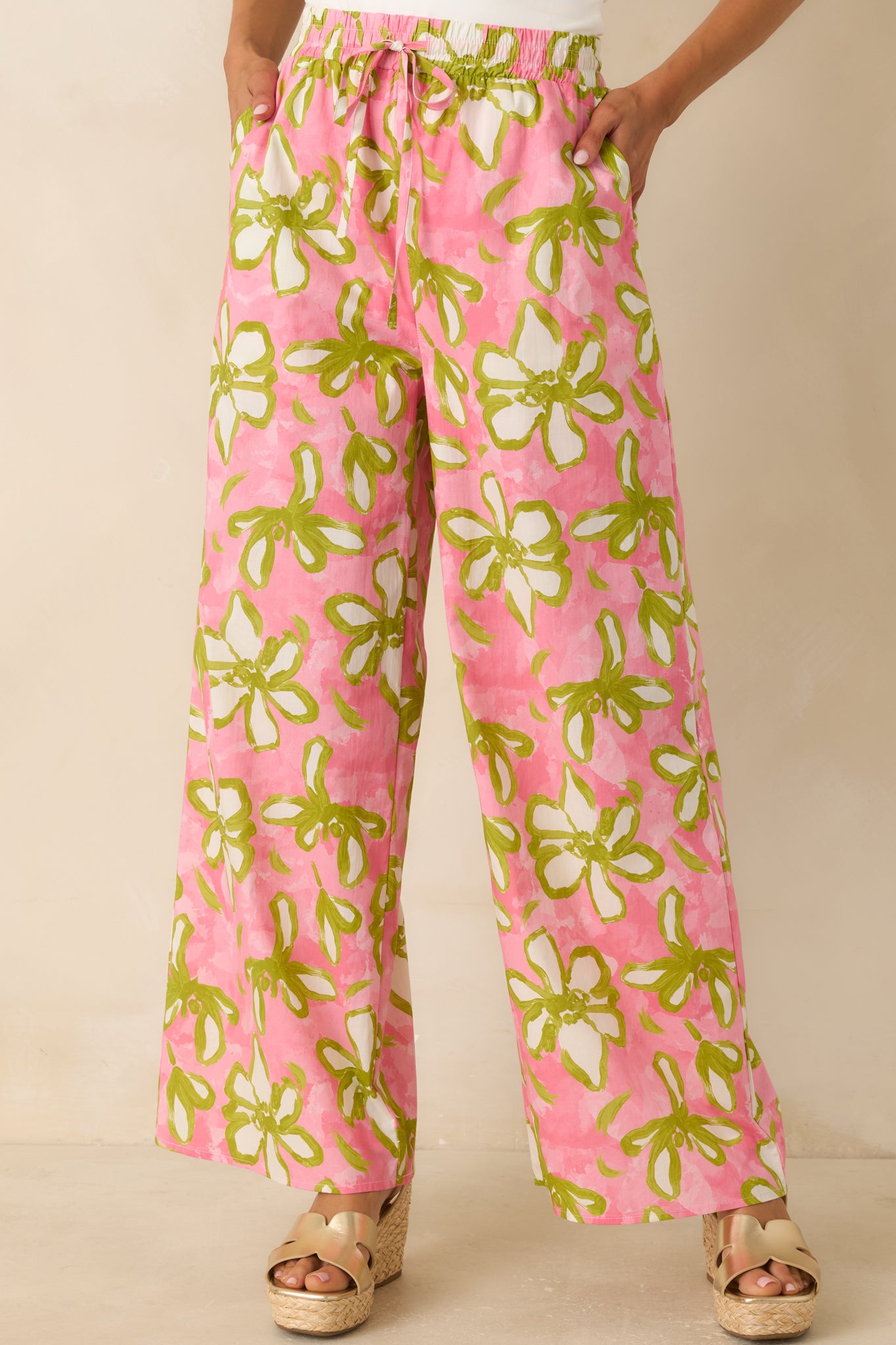 Close view of the elastic waistband highlighting the adjustable drawstring detail on the floral wide-leg pants.