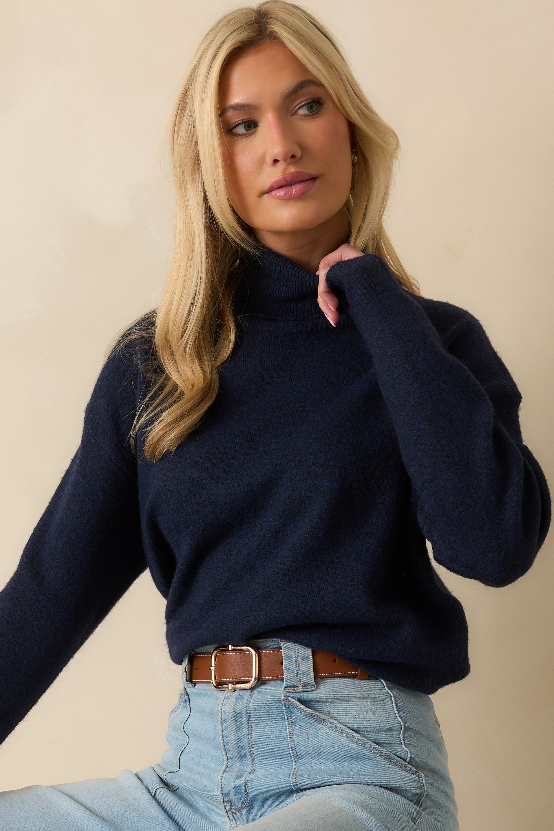 Close view of turtleneck collar and knit fabric emphasizing texture
