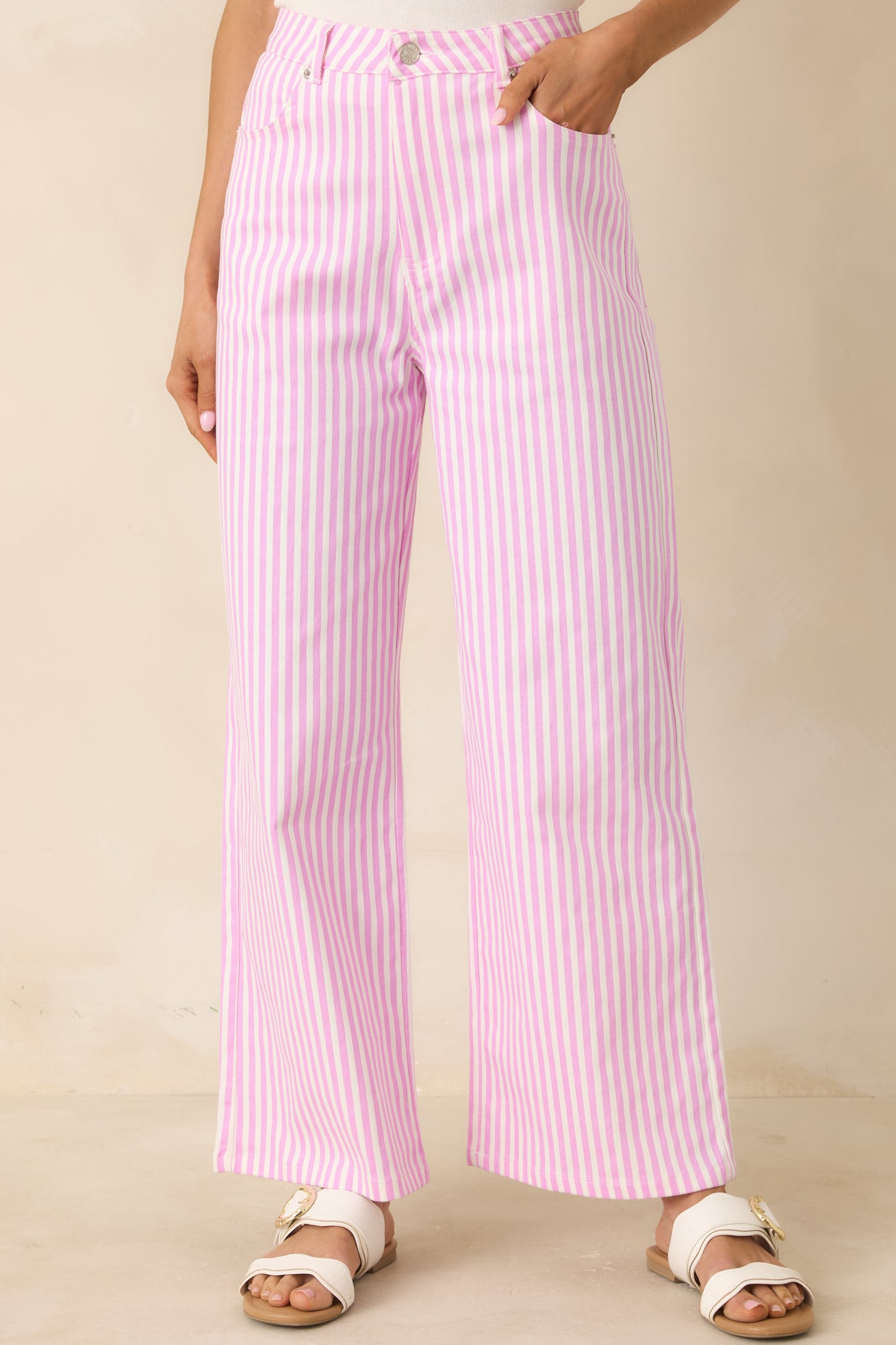 Close view of vertical stripe pattern and structured waistband on cotton pants.
