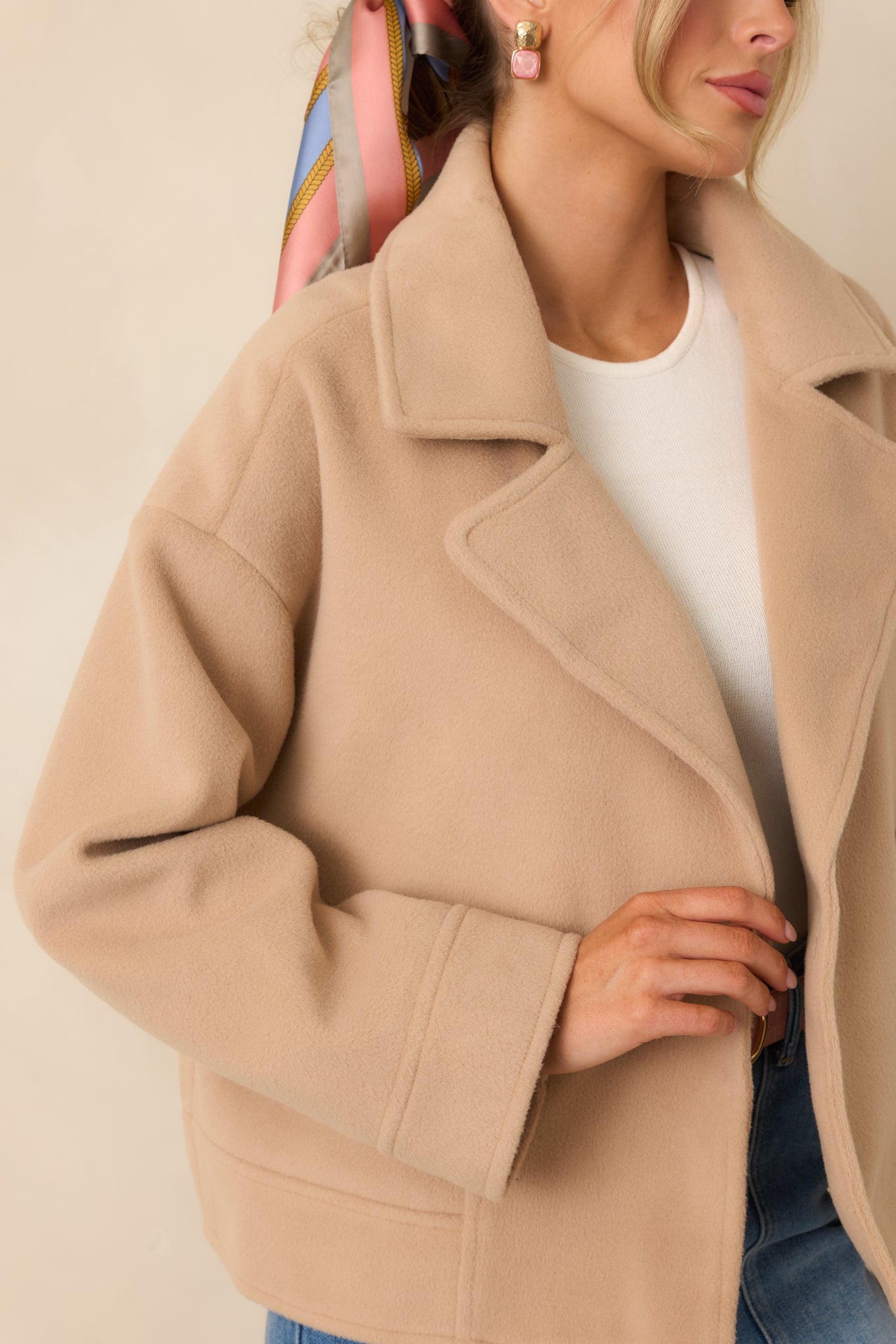Ultra close view of brushed felted fabric on the taupe jacket, showing soft fibers and structured material.