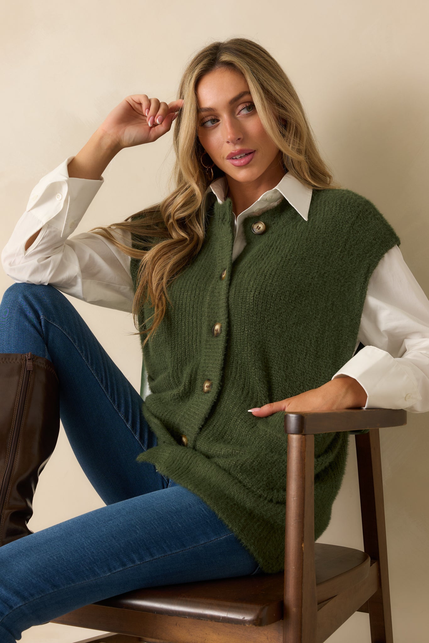 Close view of the upper front of the cardigan, emphasizing the collarless neckline and button detailing.