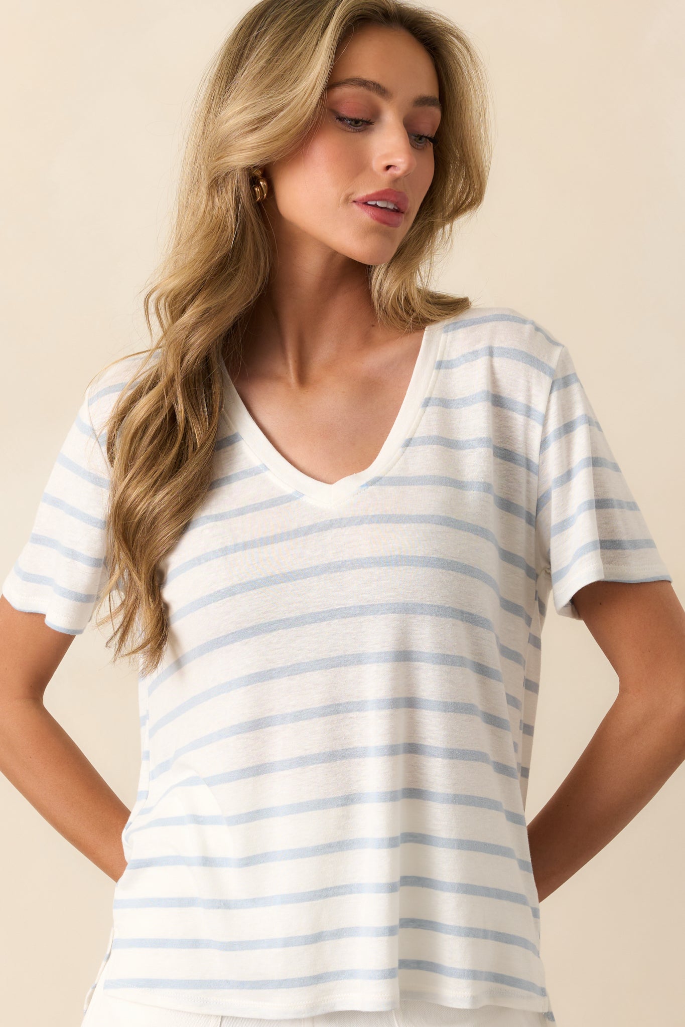 A closer look at the V-neckline and short sleeves, highlighting the top’s relaxed structure.