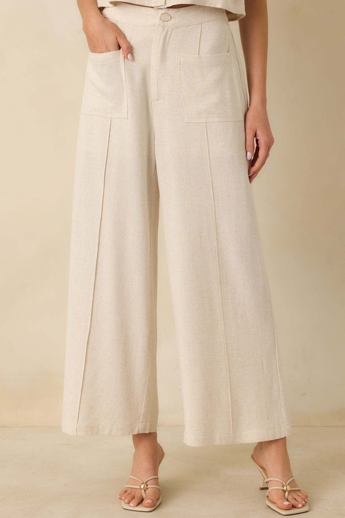 Closer view of the high-rise waistband and wide-leg silhouette in lightweight linen-blend fabric.
