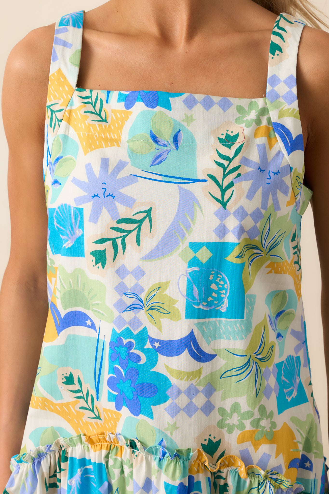 A closer view of the delicate ruffle accents and keyhole closure, adding a touch of texture to the tropical print dress.