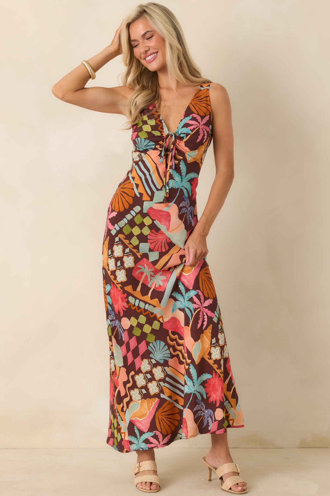 Coastal print midi dress featuring a V-neckline, adjustable tie-front keyhole detail, and a flowing feminine silhouette.