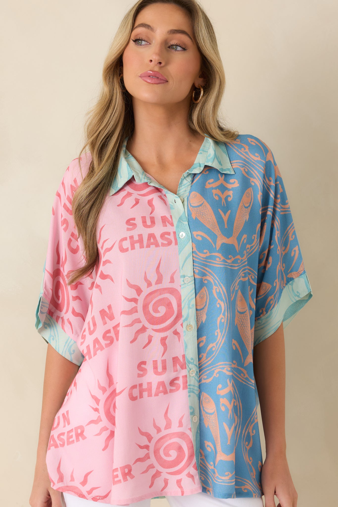 Coastal print top featuring a classic collar, vibrant motifs, and smooth lightweight fabric texture.