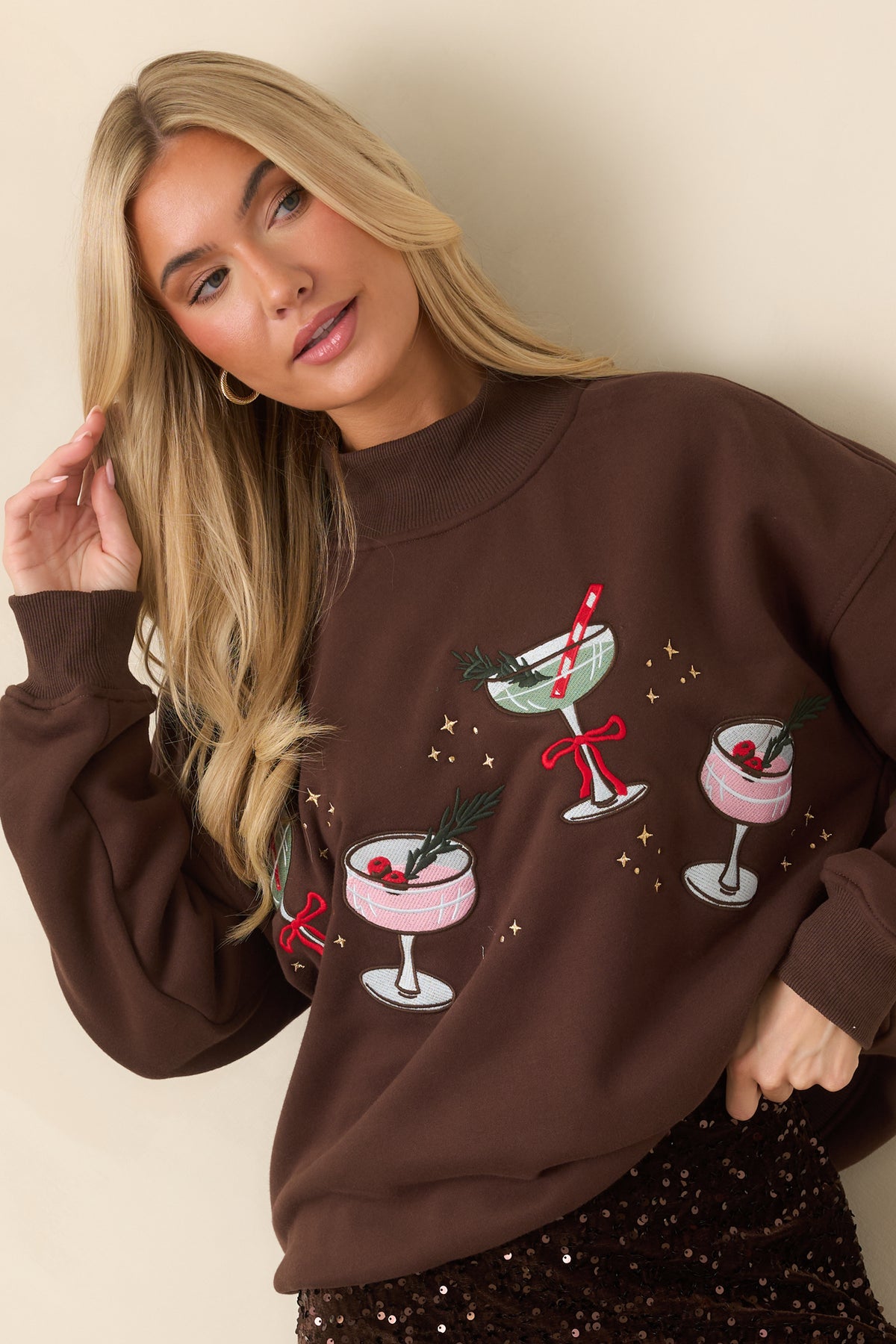 Cocoa brown top highlighting pink and sage cocktail embroidery accented by red bows and tiny gold stars.