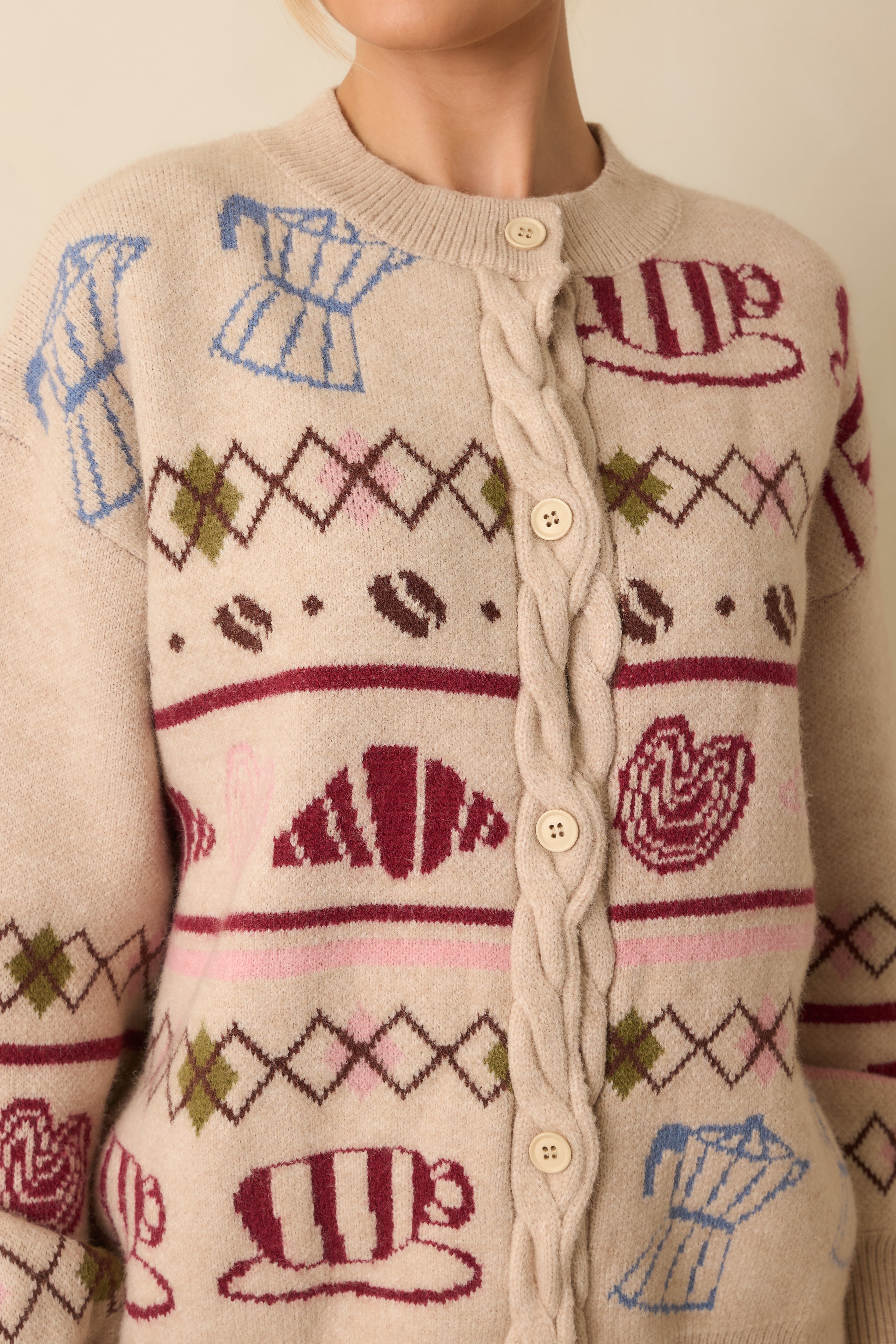 Close-up of the coffee and pastry knit motif and cable-knit trim, emphasizing the soft texture and fine stitching.