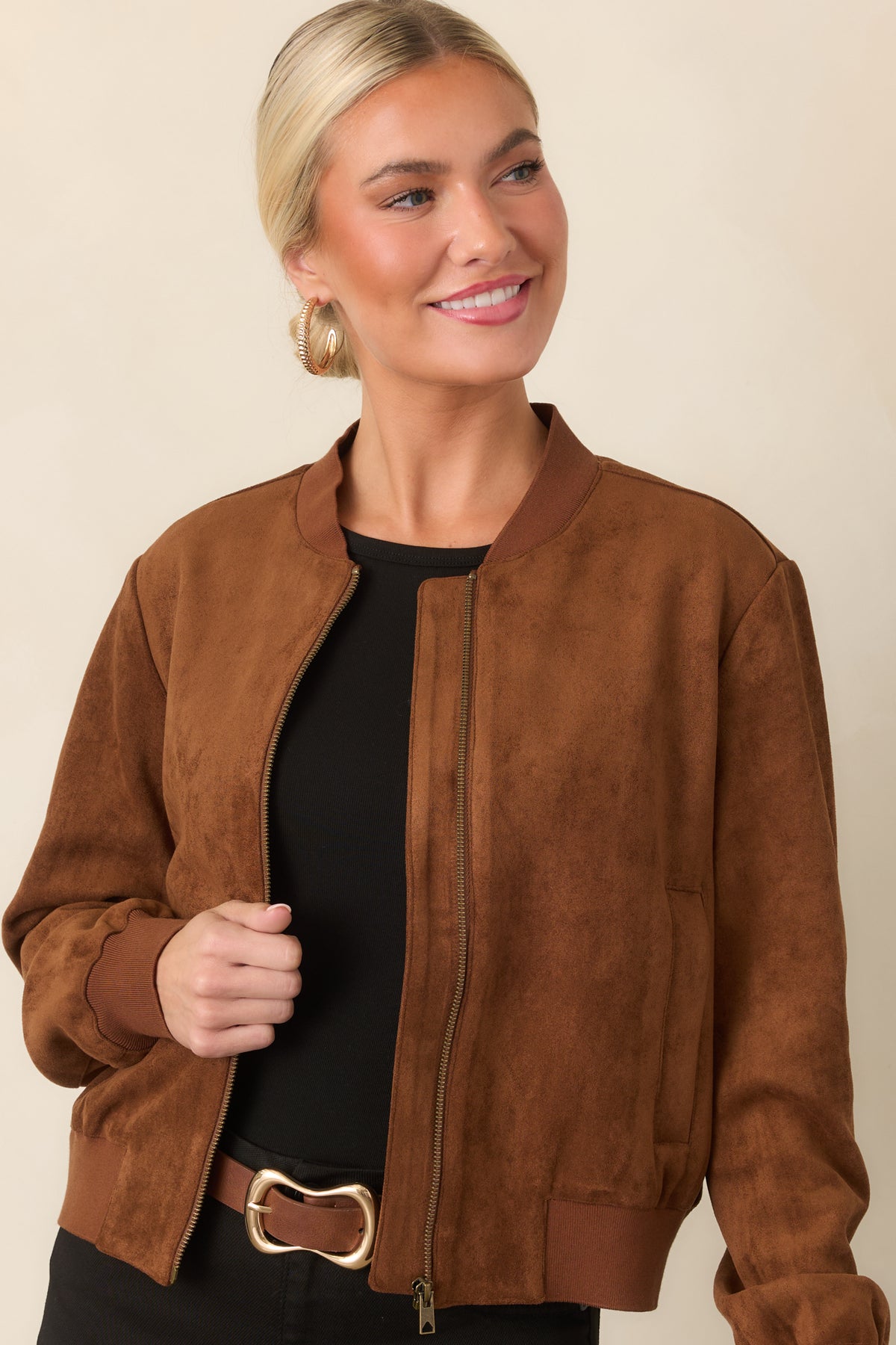 Cognac faux suede jacket featuring ribbed cuffs and a relaxed sleeve silhouette.