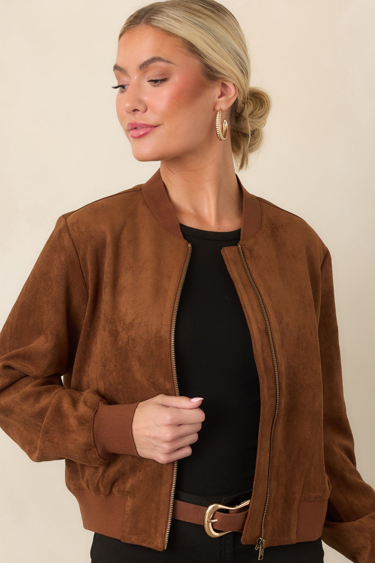 Cognac jacket with functional side welt pockets, ribbed trim, and smooth faux suede construction.
