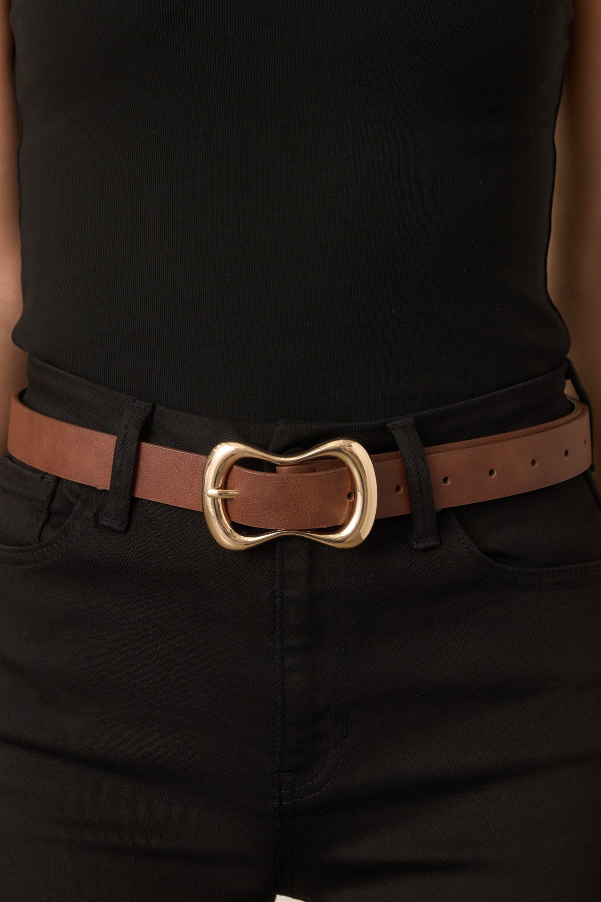 Cognac strap with an oversized gold-tone buckle featuring an organic curved silhouette.