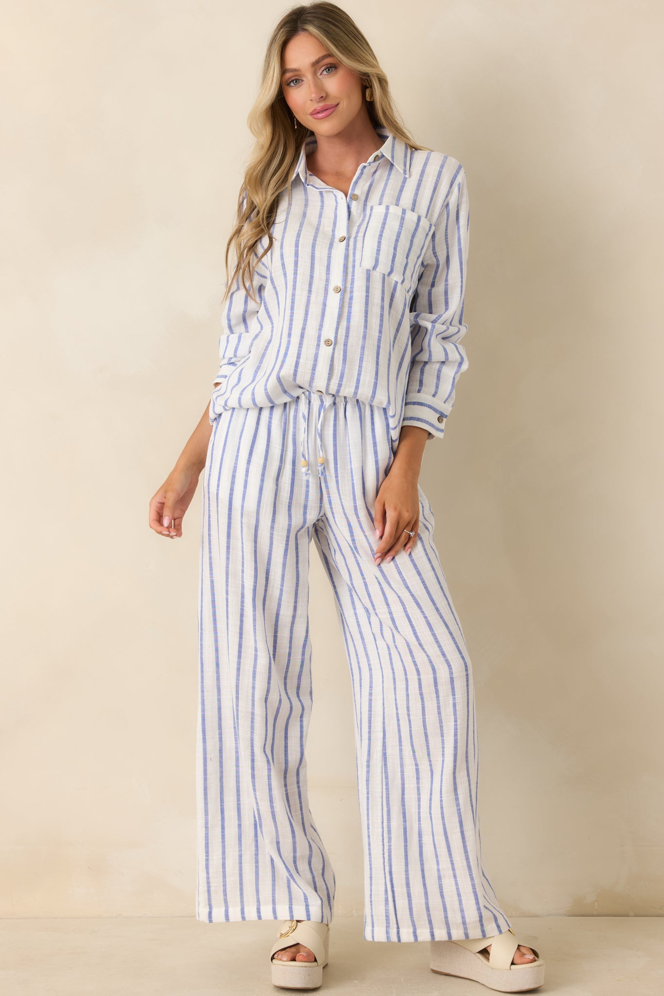 Collared blue striped shirt featuring a chest pocket, relaxed fit, and soft gauzy cotton texture.