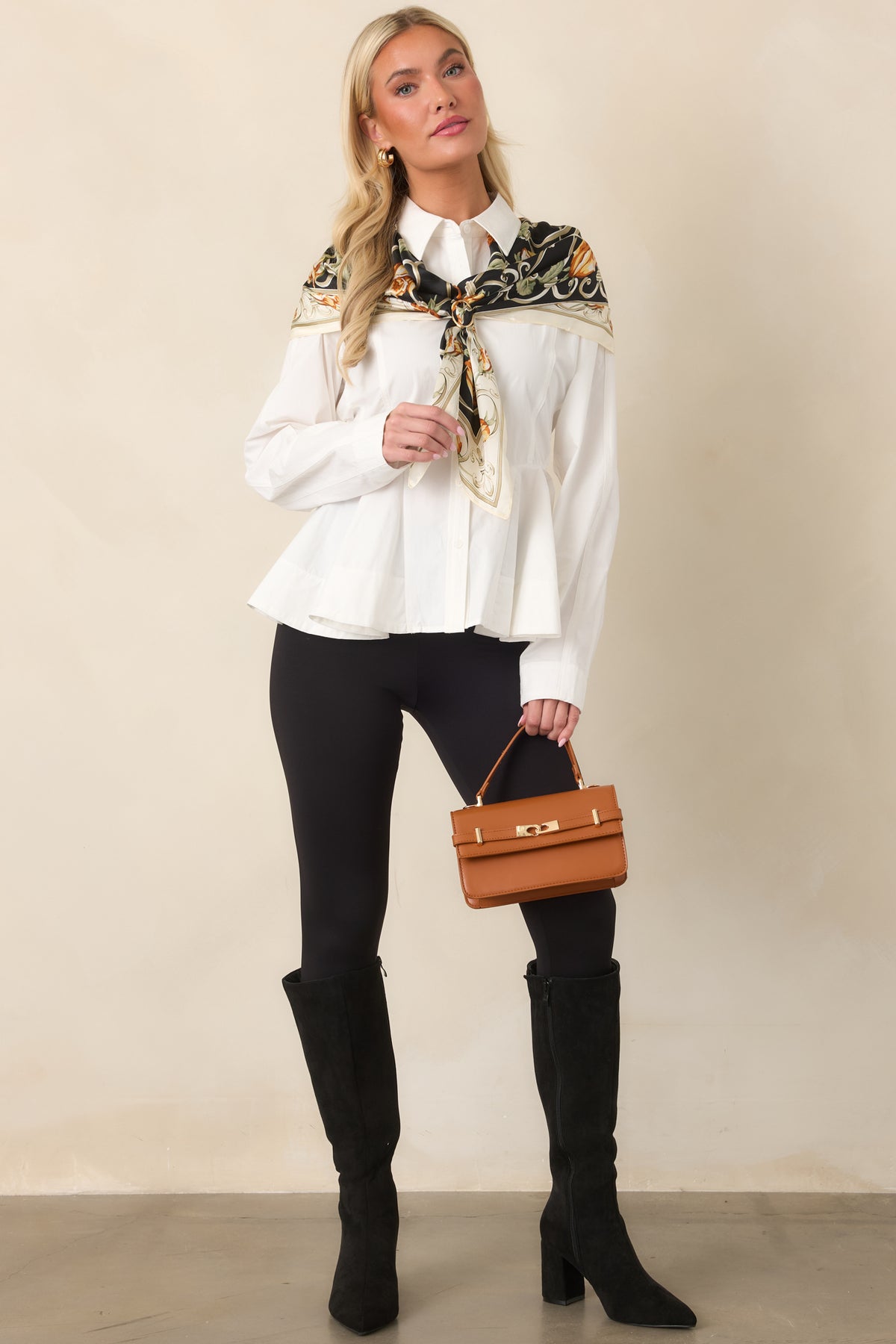Collared cotton top showcasing a fitted waist, flared peplum hem, and polished full button-front design.

