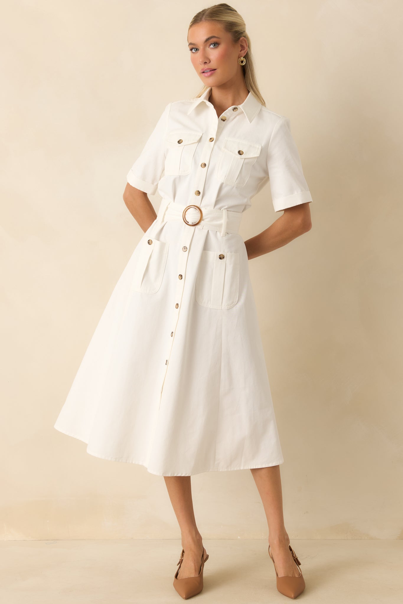 Cotton twill midi dress featuring a collared neckline, button-front closure, cuffed short sleeves, and a coordinating belt with a statement buckle.