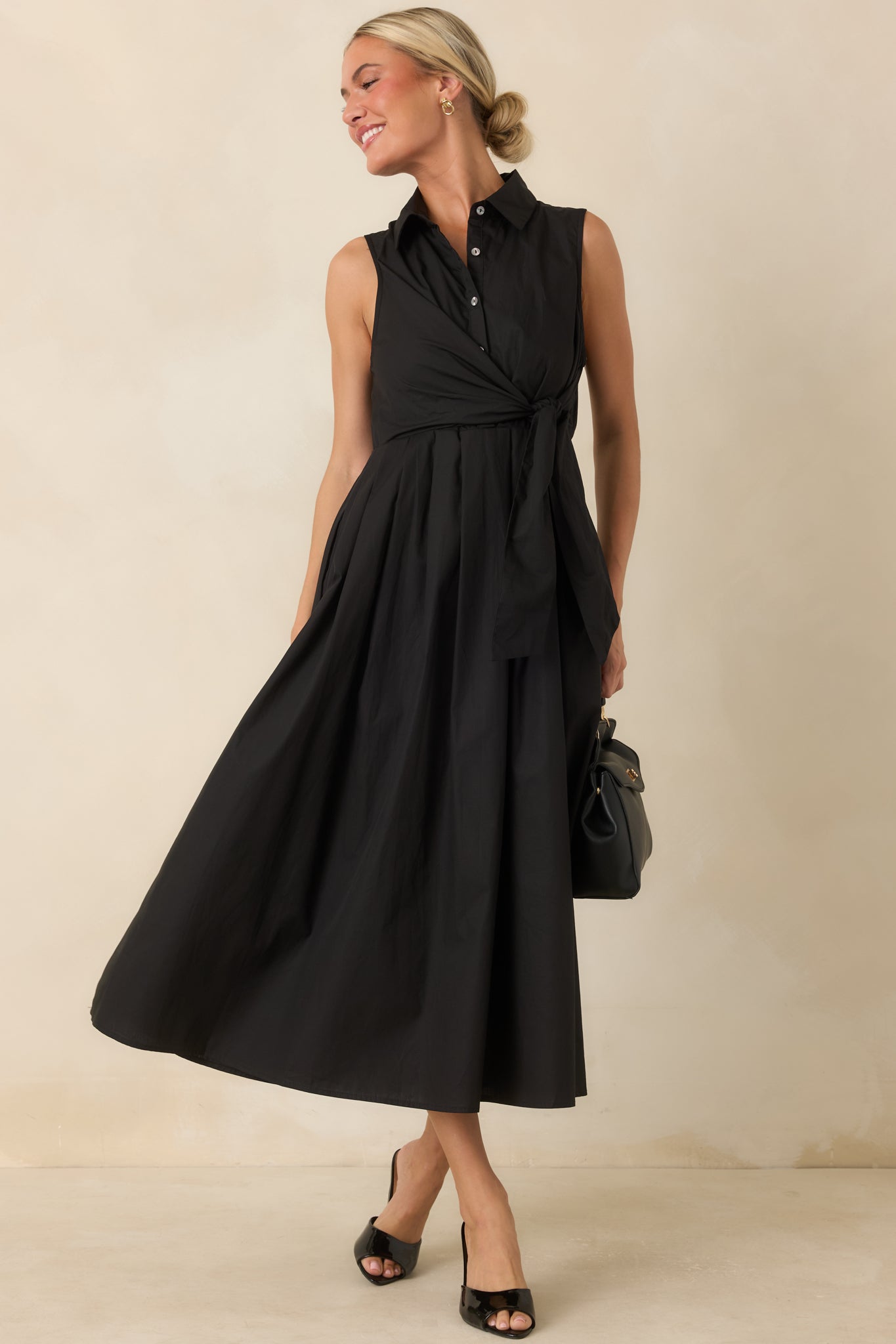 Collared midi dress featuring a button-front bodice, gathered skirt, and timeless sleeveless design.